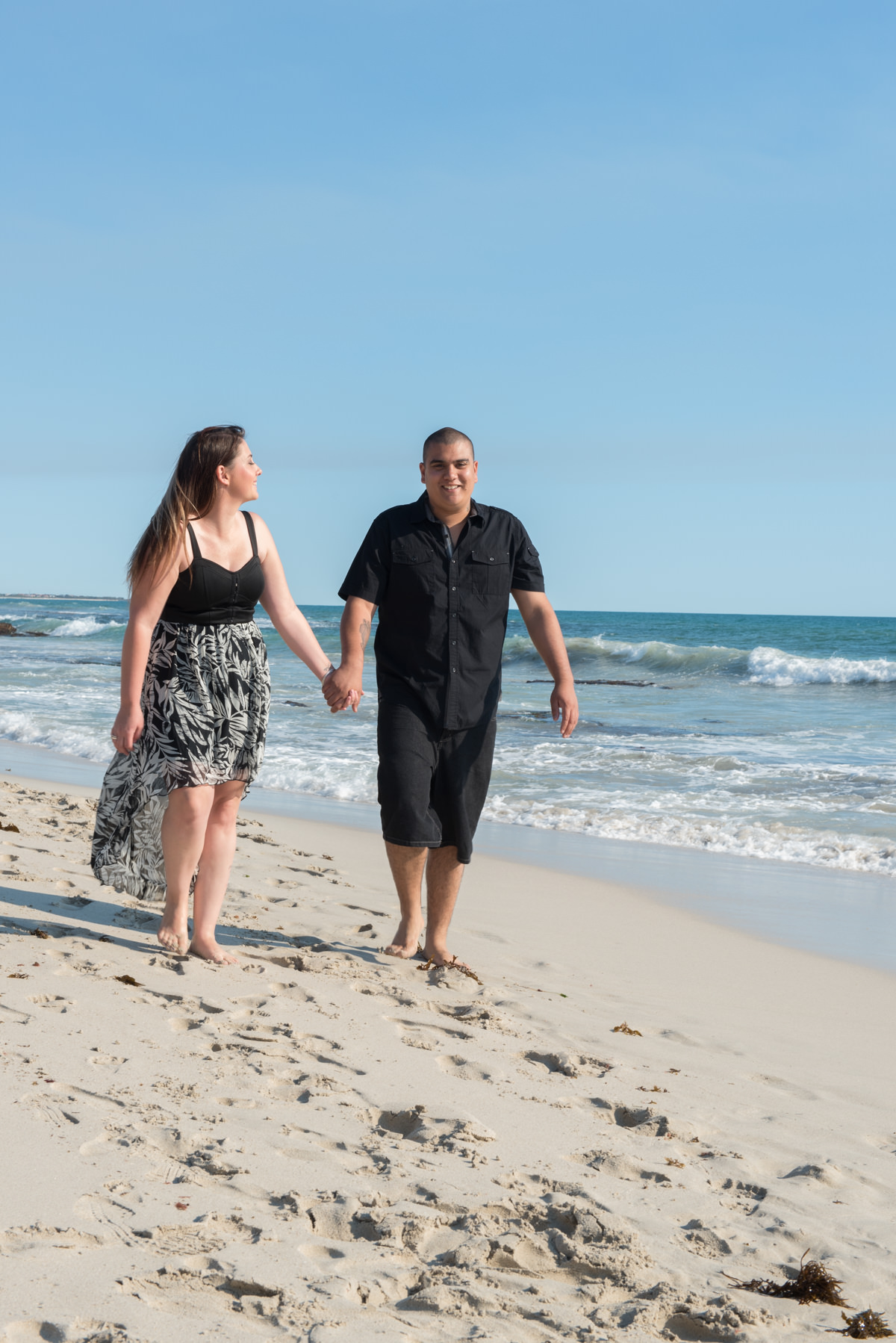 couple walking along the sands at Burns Beach