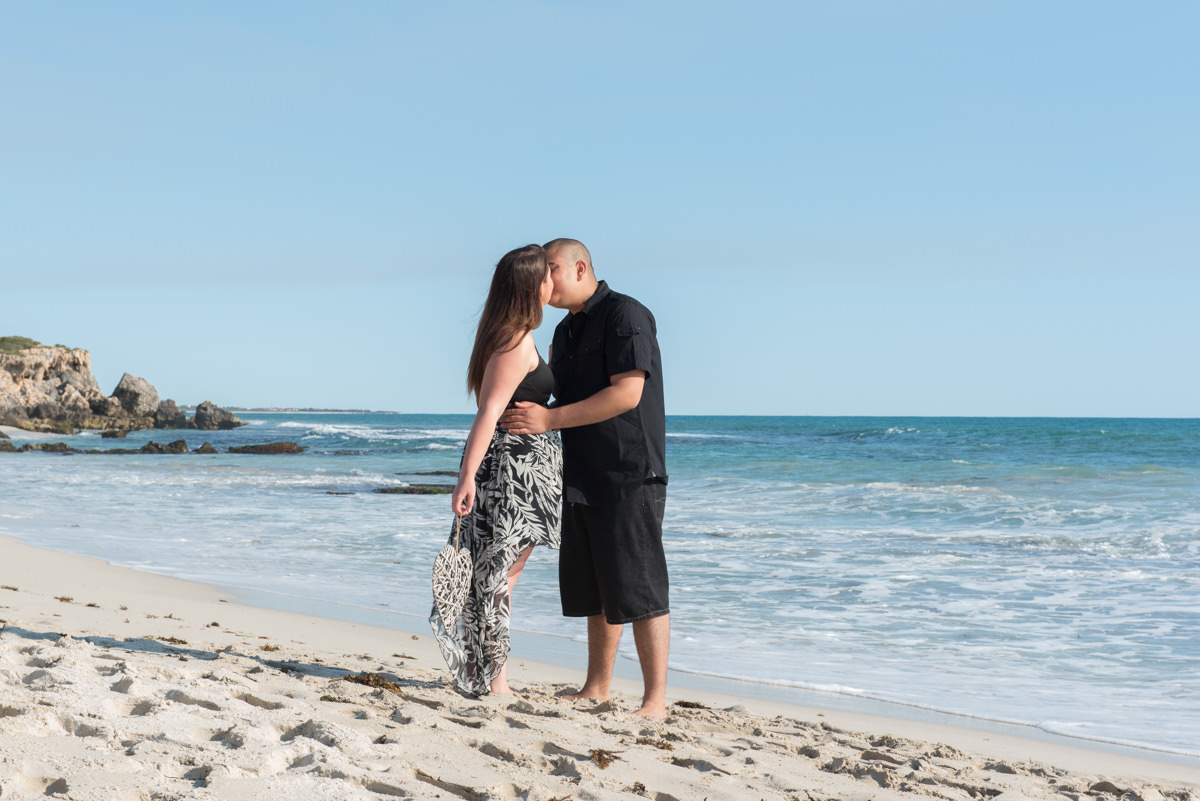 couple kissing on the beach sands