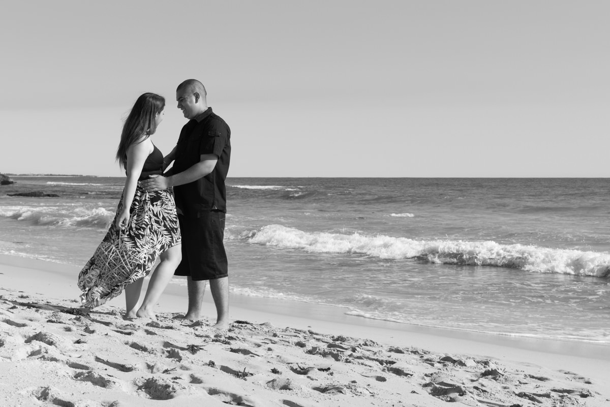 engaged couple together on the beach