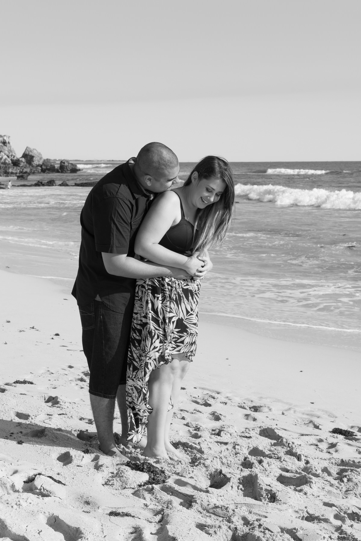 couple snuggling on the sand