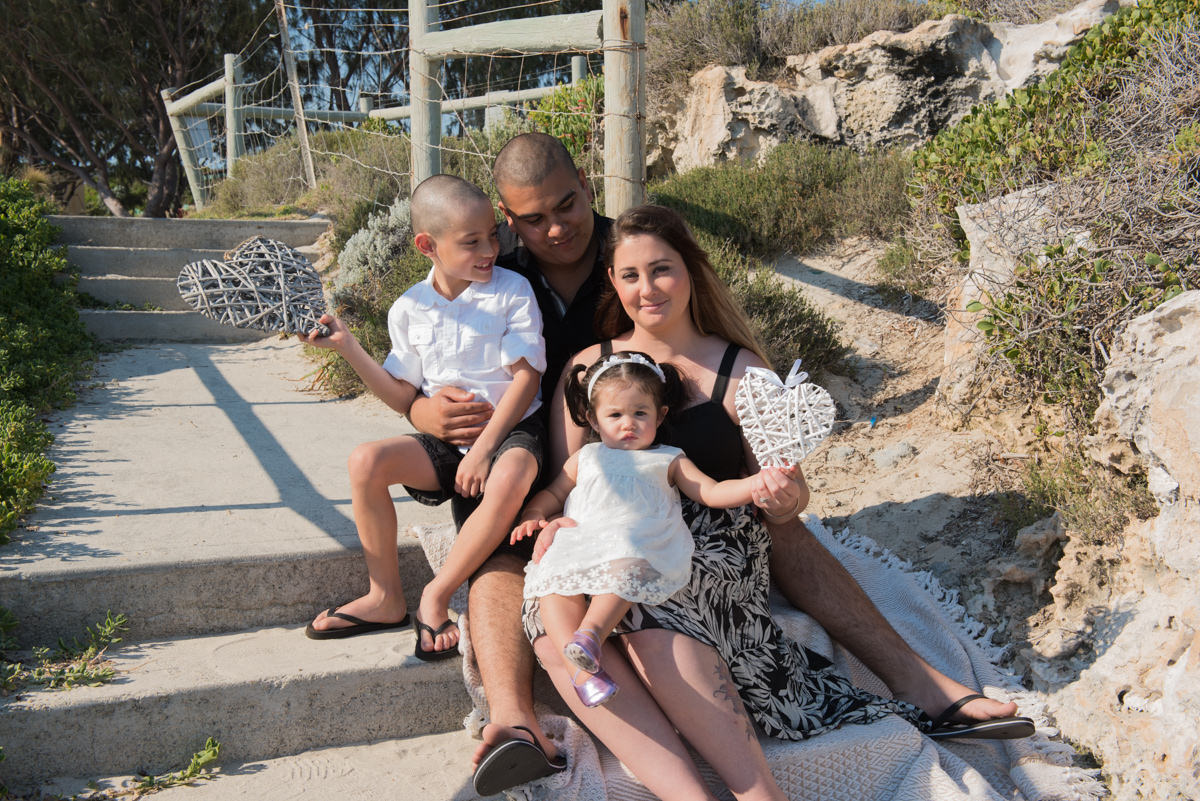 family photo holding white decorative hearts