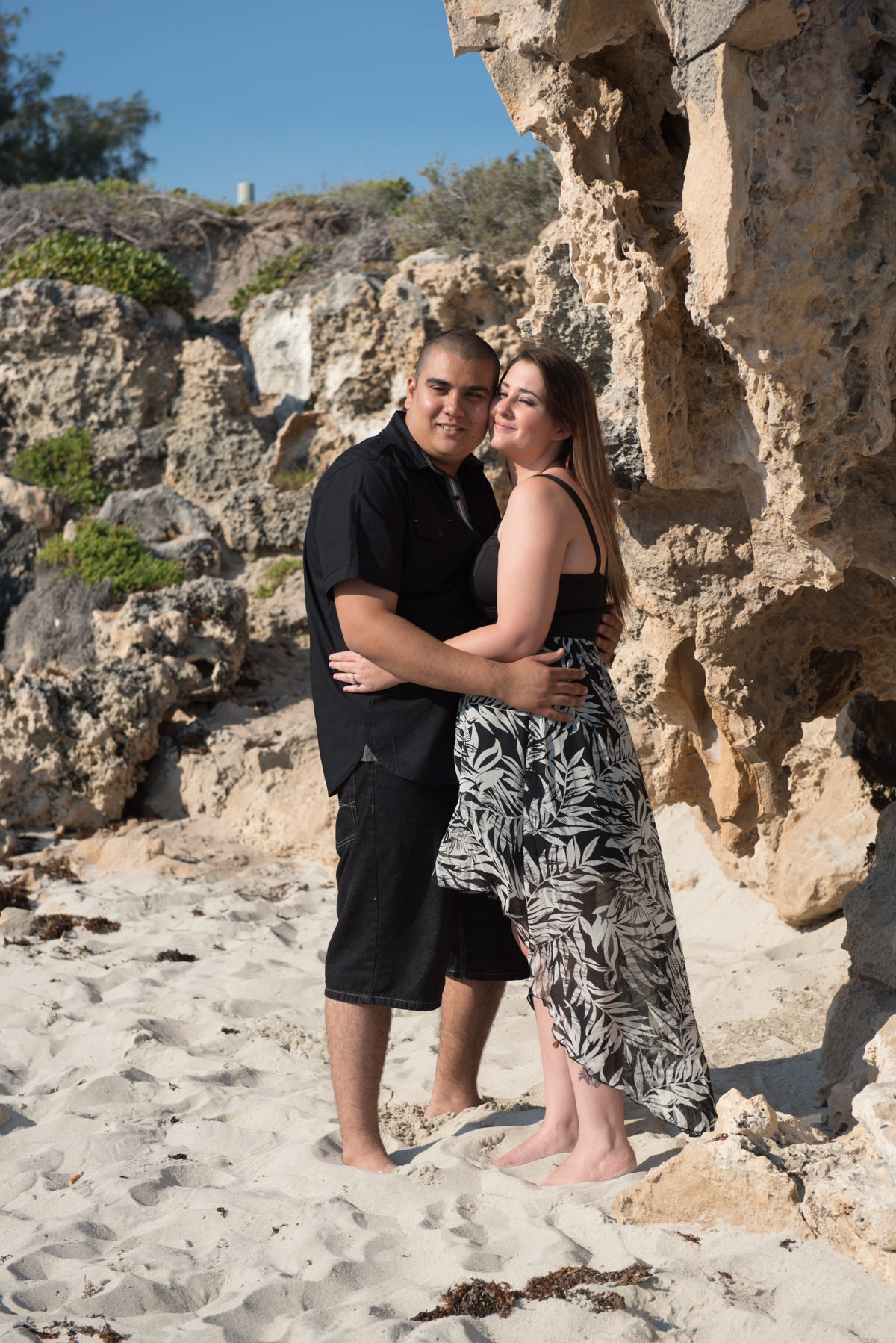 cuddling couple on the sand