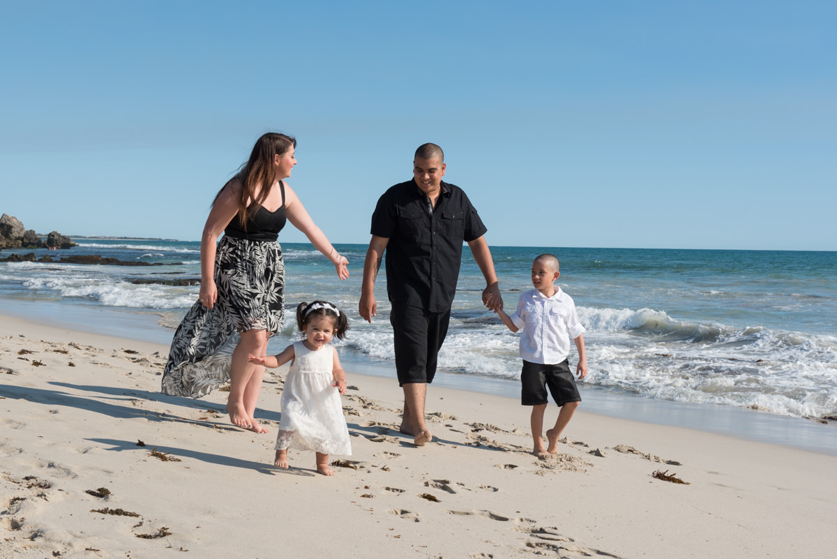 family walking on the sand