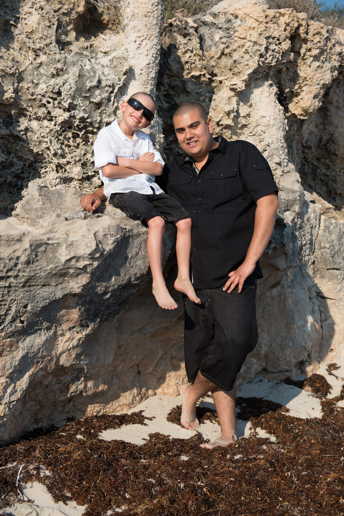 father and son portrait on the beach rocks