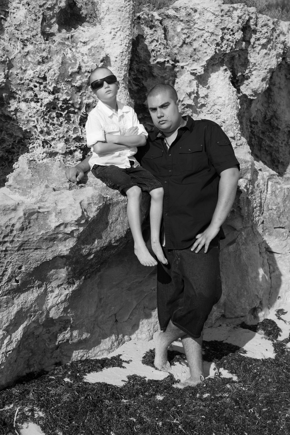 father and son looking cool on the beach rocks