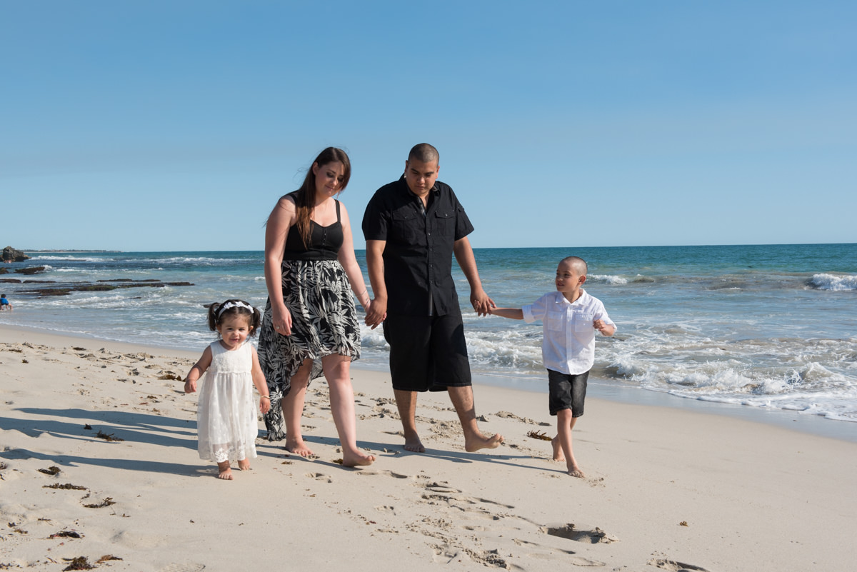 family walking together on the sand