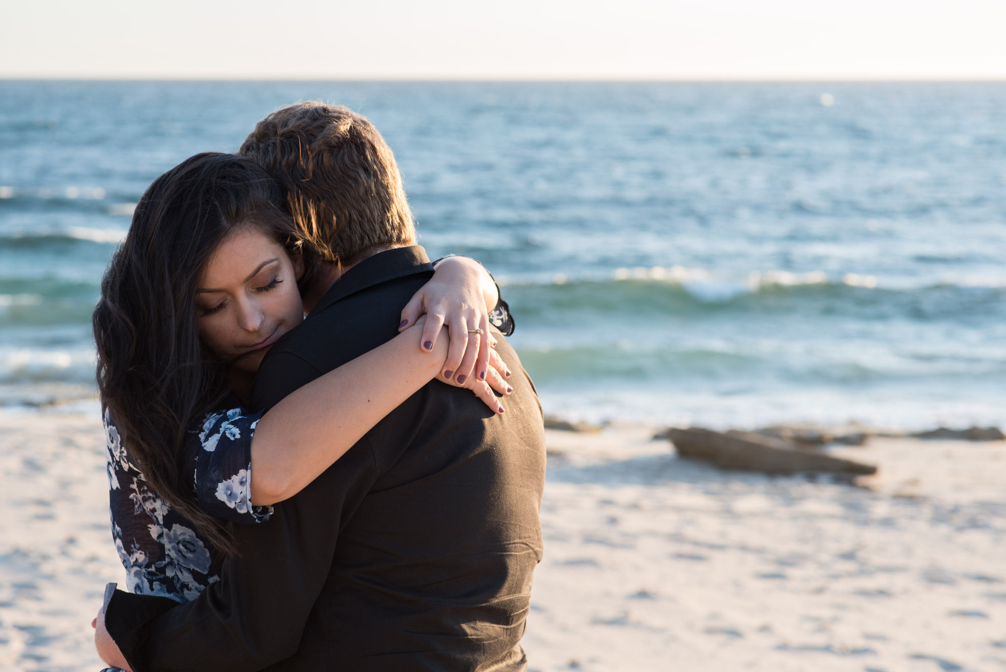 Girl hugging boy at the beach