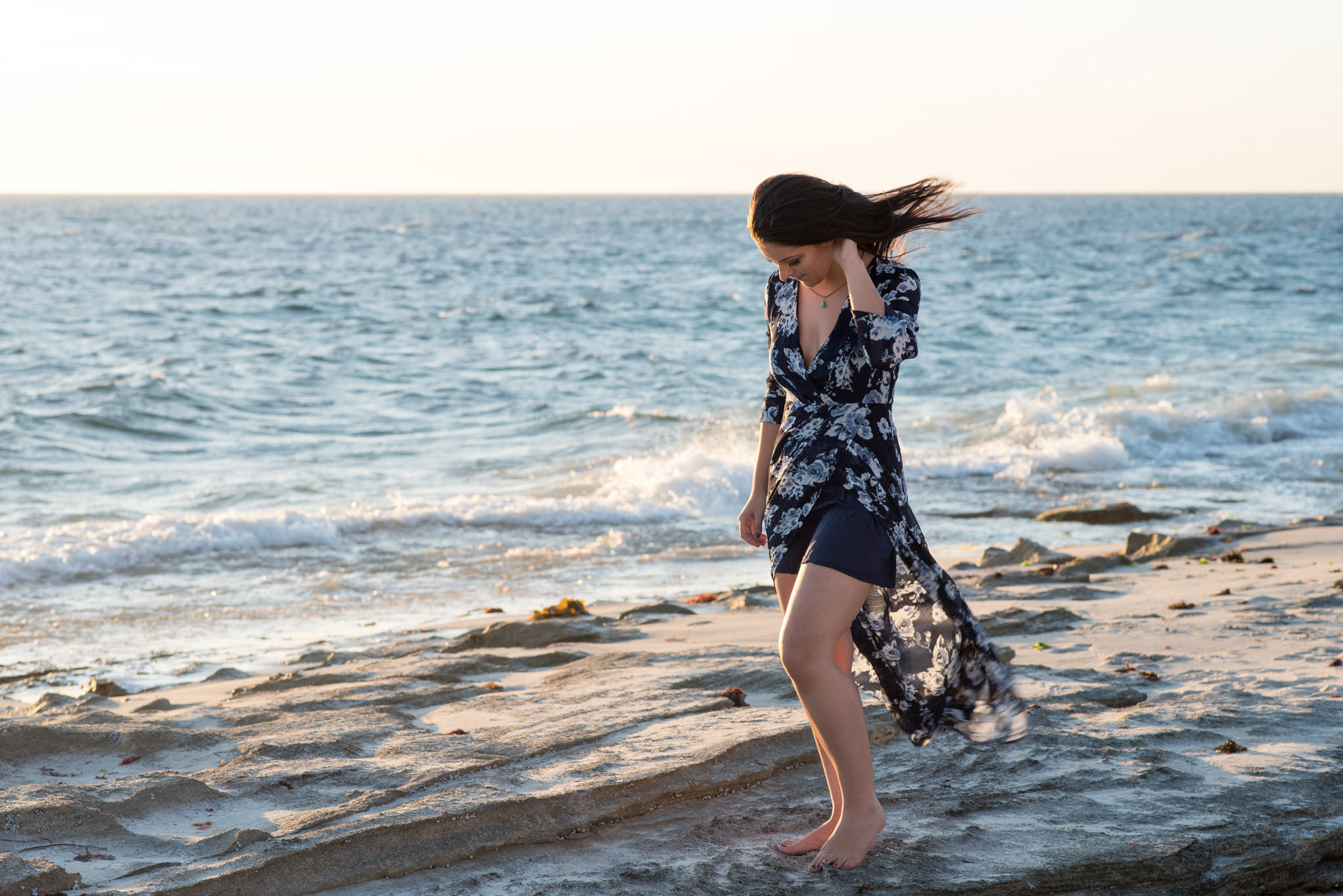 Girl flicking her hair at Burns beach on the rocks