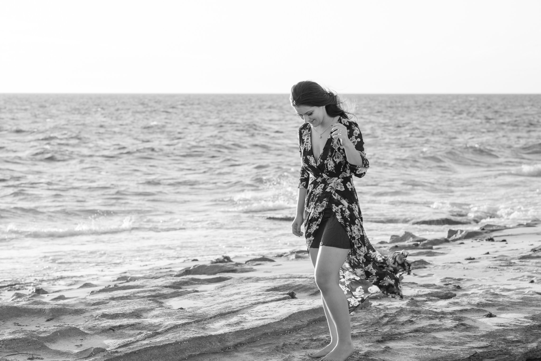 Girl standing on the rocks at the beach