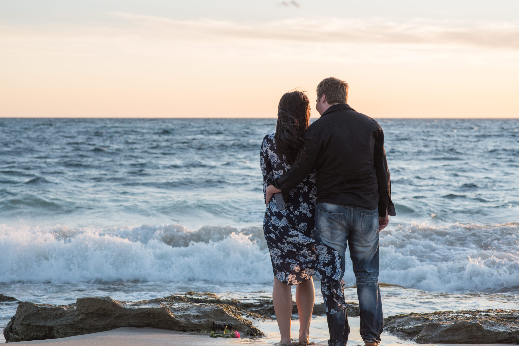 Boy and girl looking at sea at Burns beach