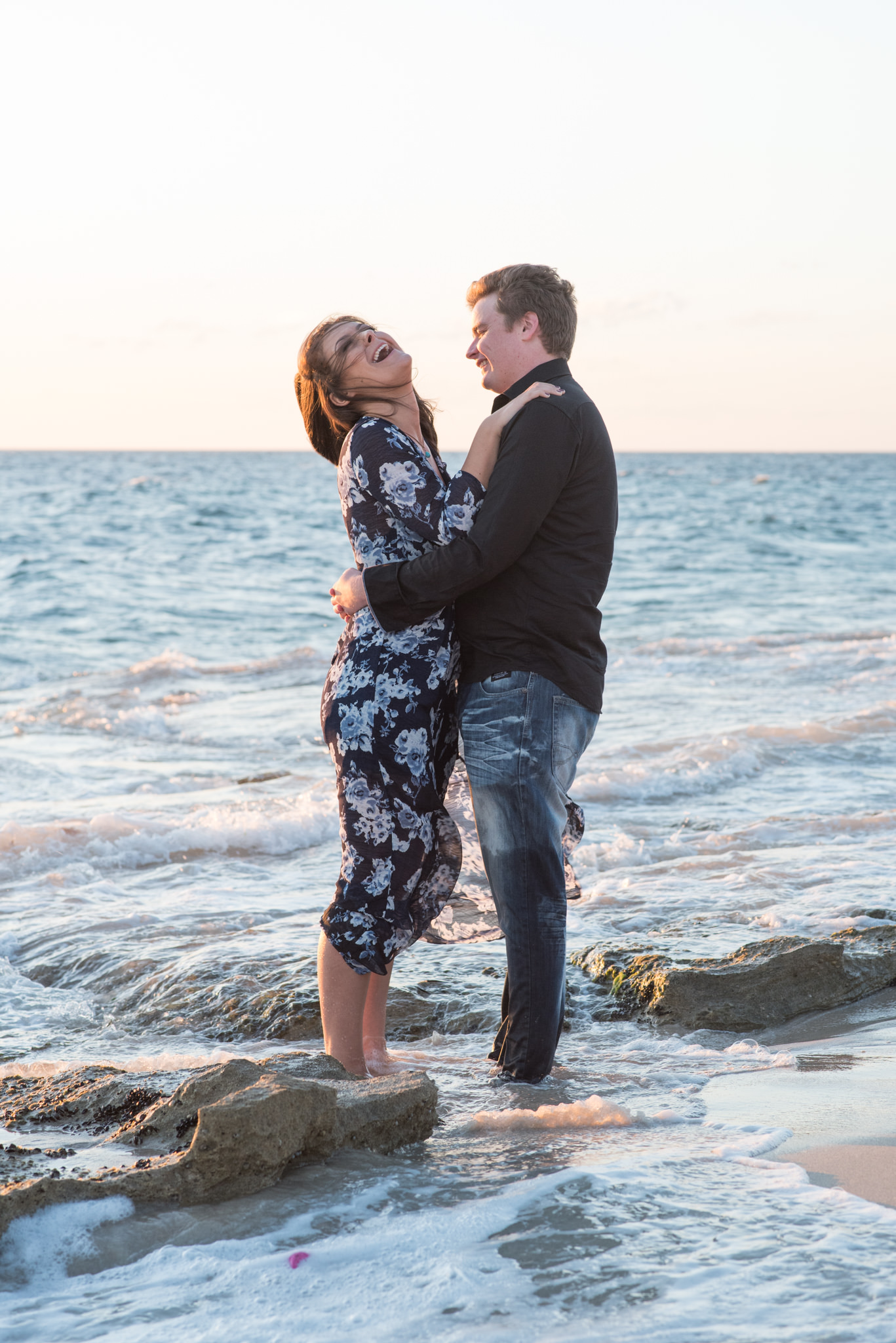 Girl laughing with boy in water at Burns beach