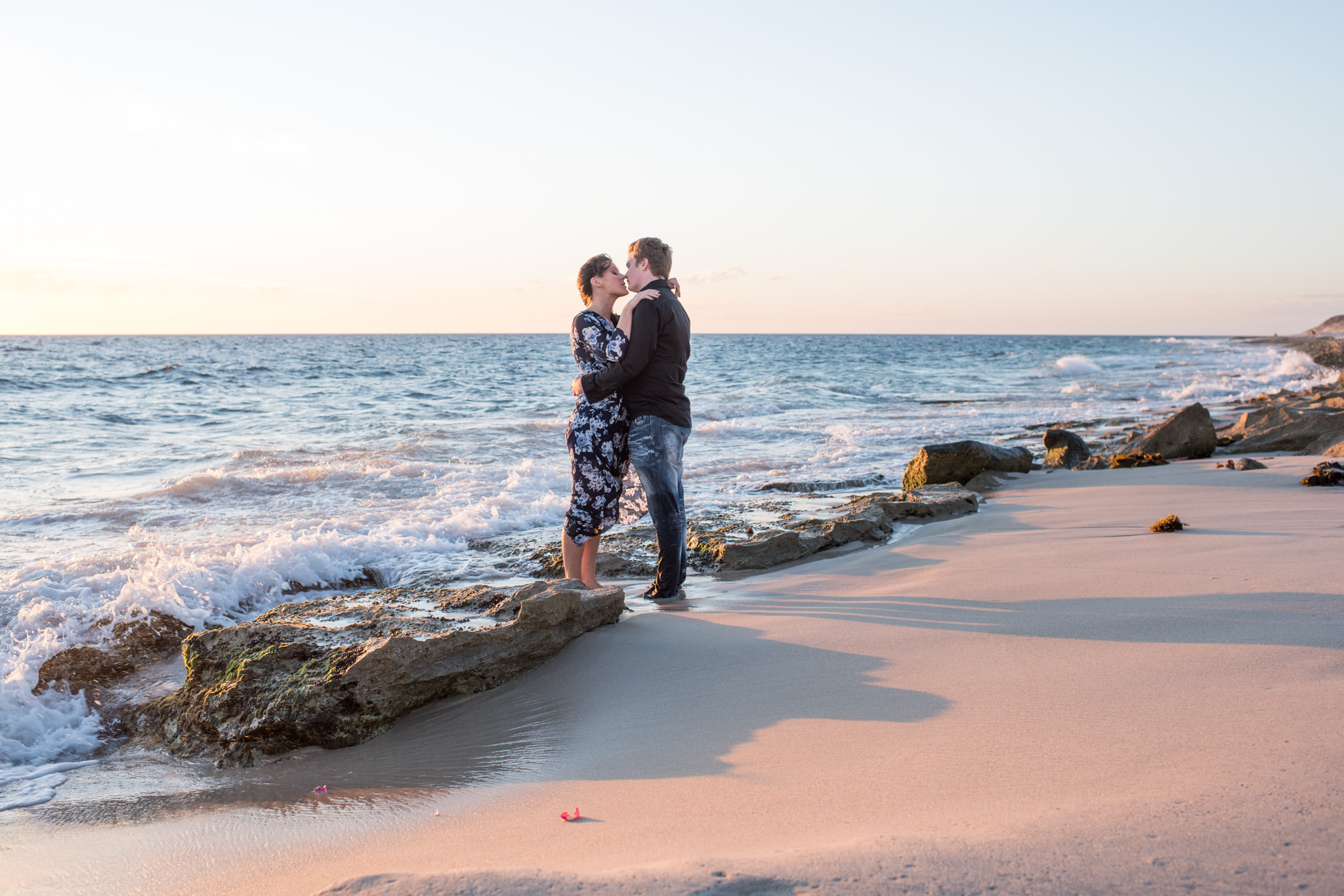 Boy and girl almost kissing on Burns beach