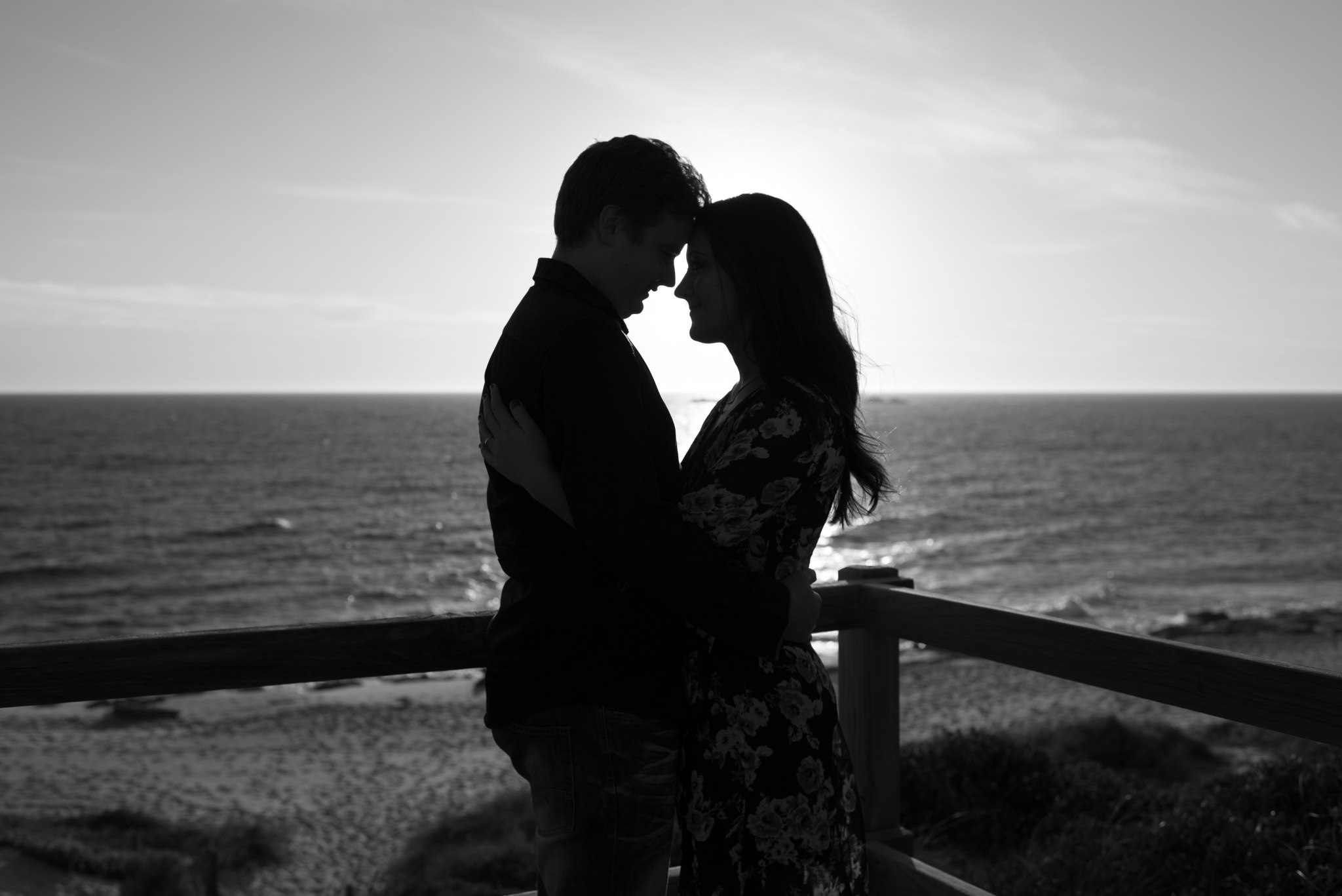 Black and white silhouette of couple at Burns beach