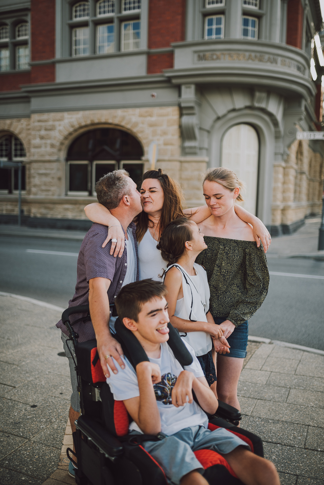 family group hug on Fremantle street corner