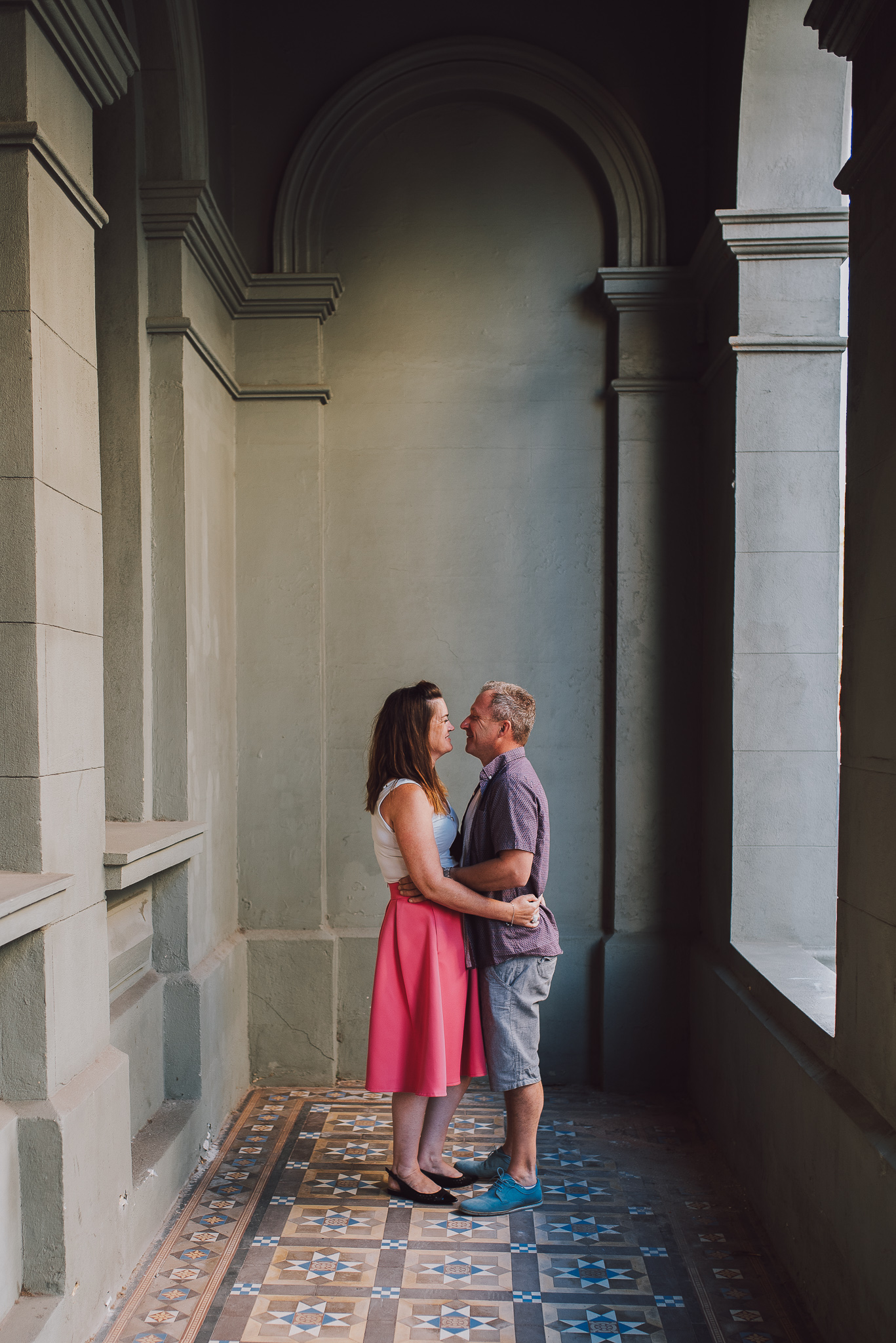 engaged couple cuddling in vintage verandah in Fremantle