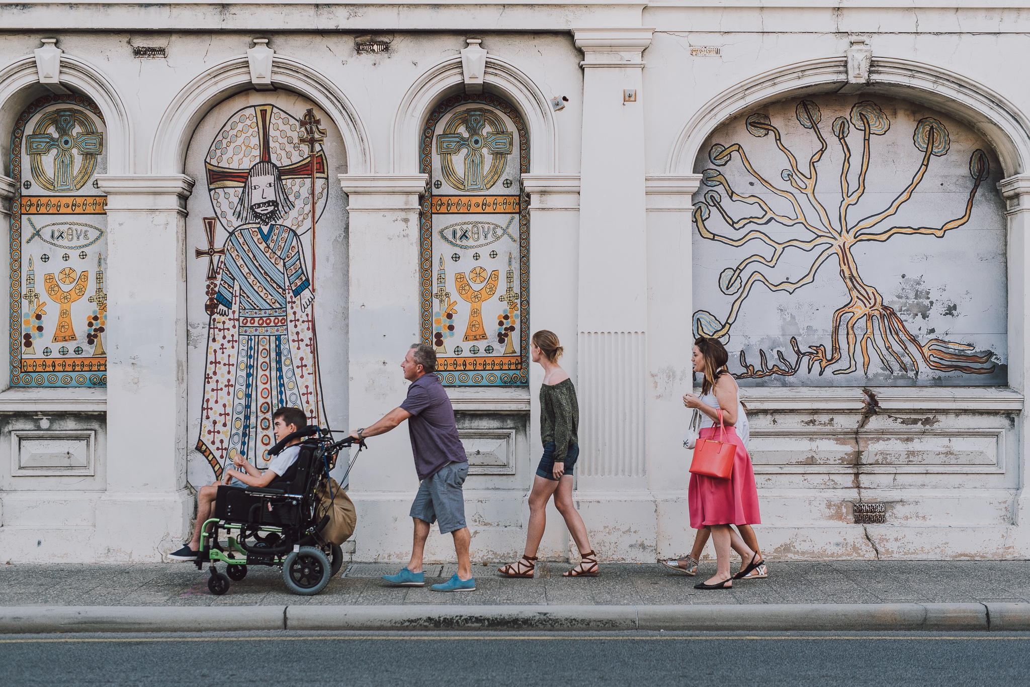 family walking along back streets of fremantle