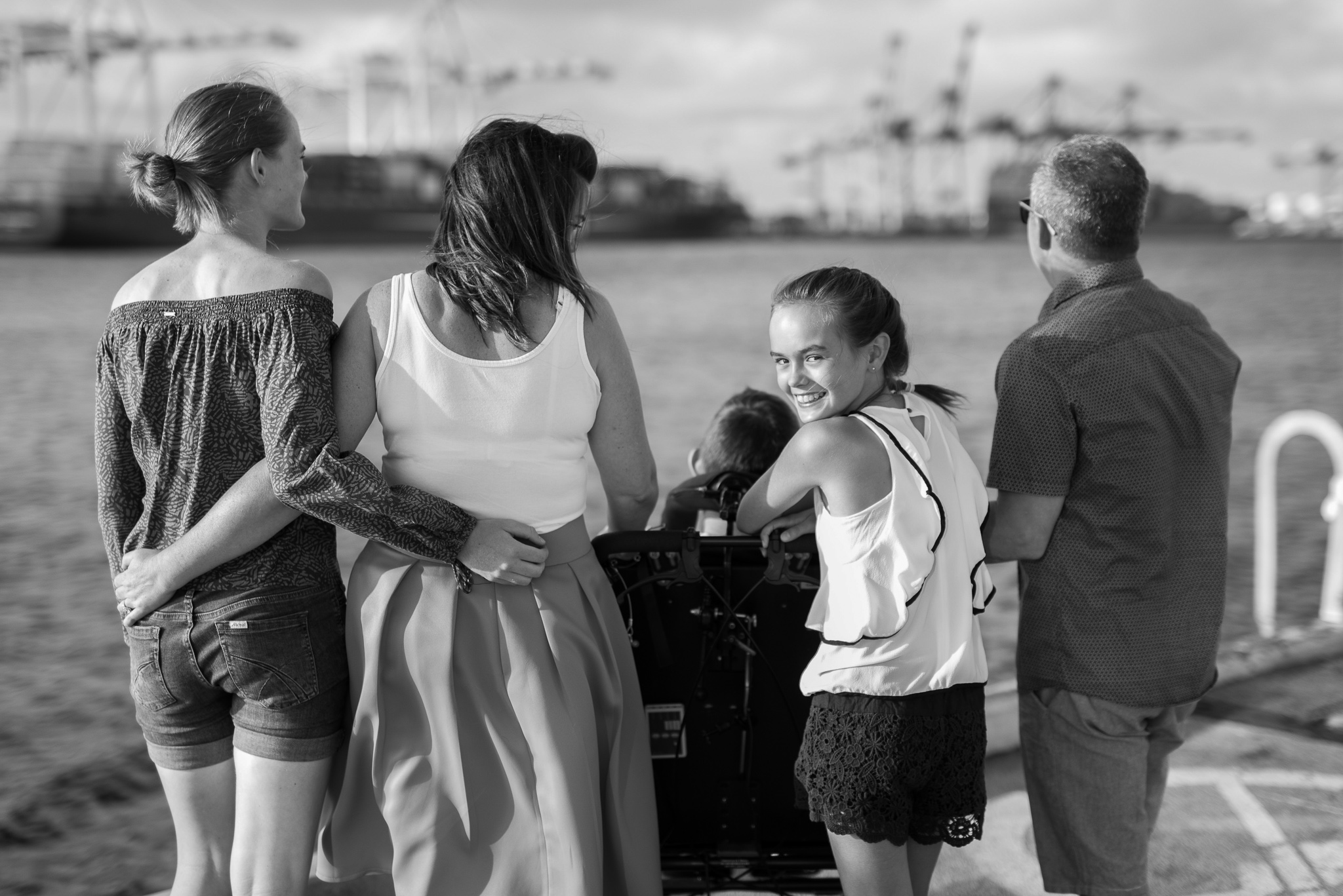 little sister looking over her shoulder at the camera at Fremantle wharf