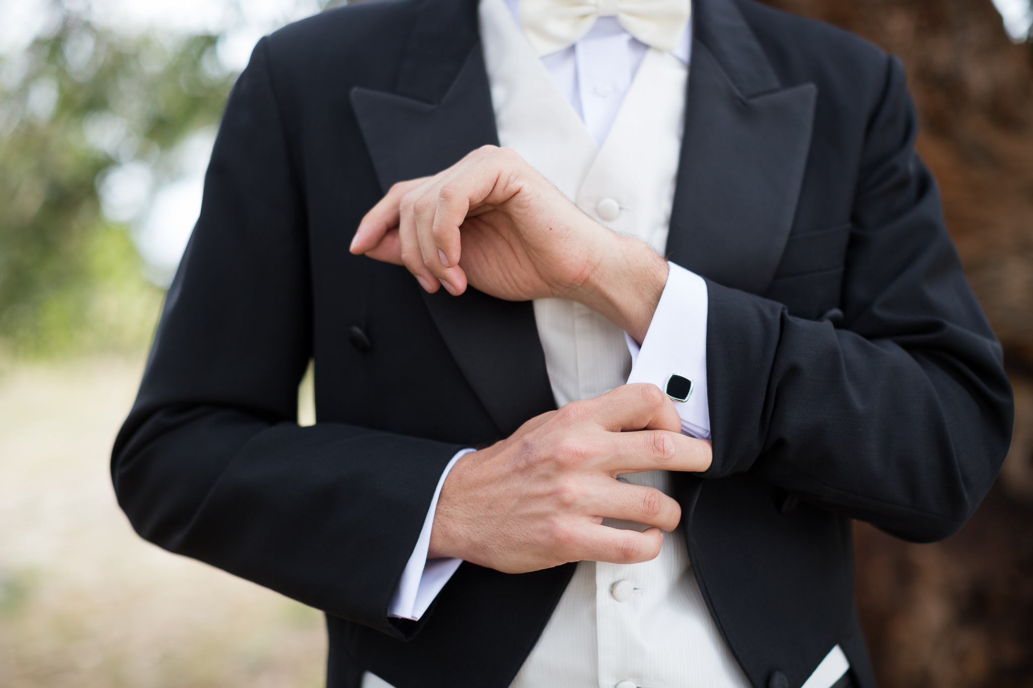 Groom adjusts his cufflinks at Serena Metta Retreat