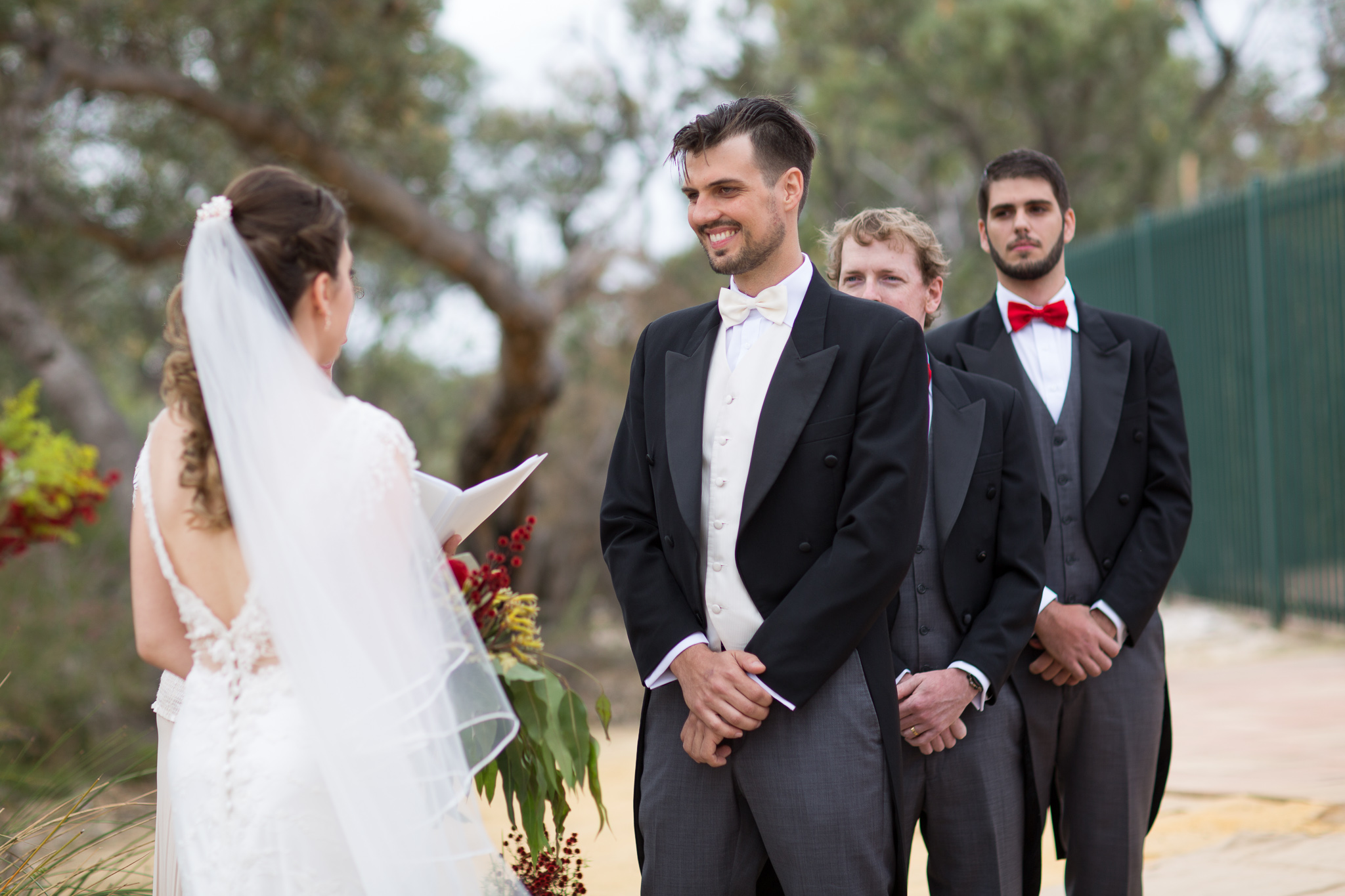 Groom looks at bride during wedding at GDC