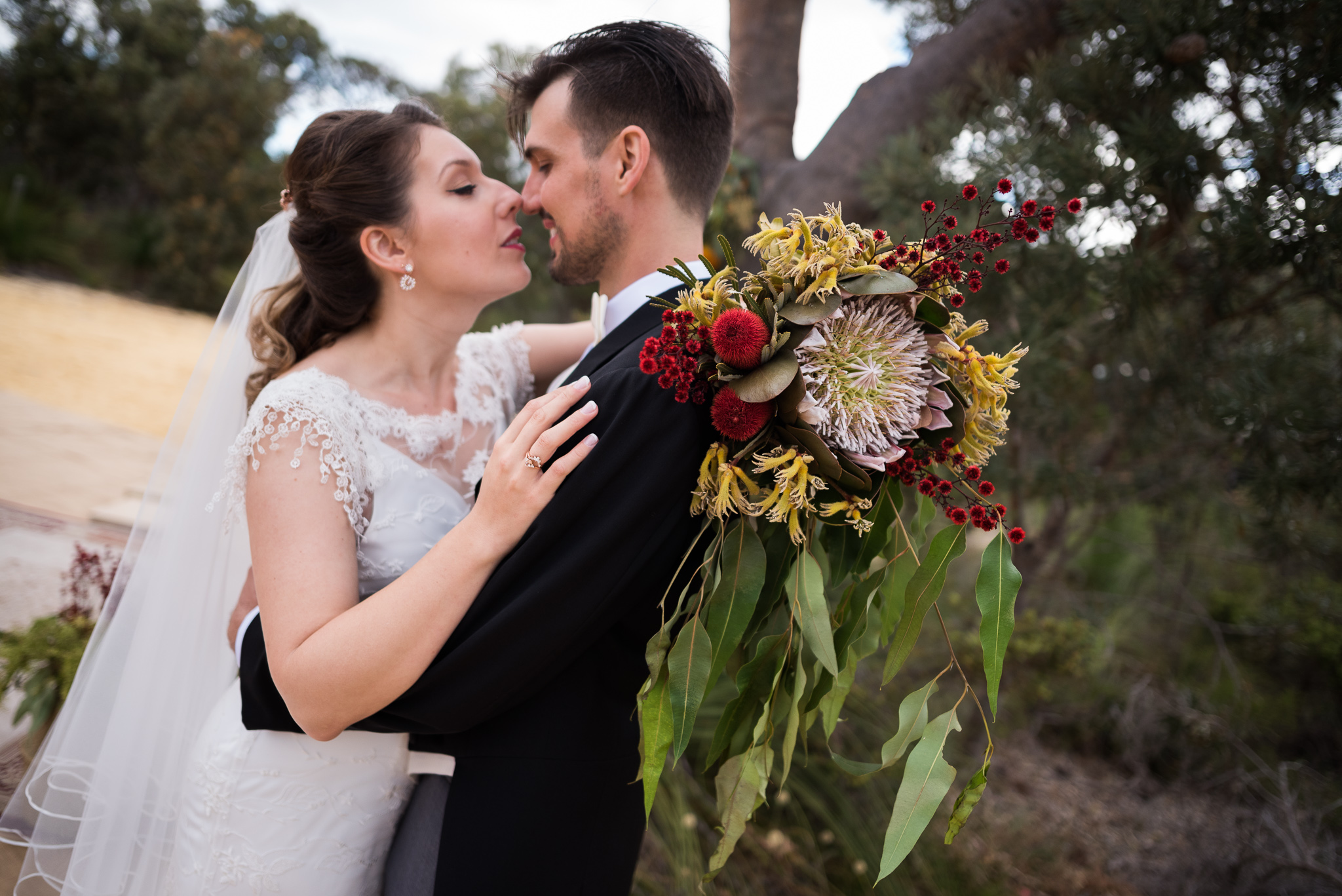 Romantic portrait of bride and groom with wildflower bouquet