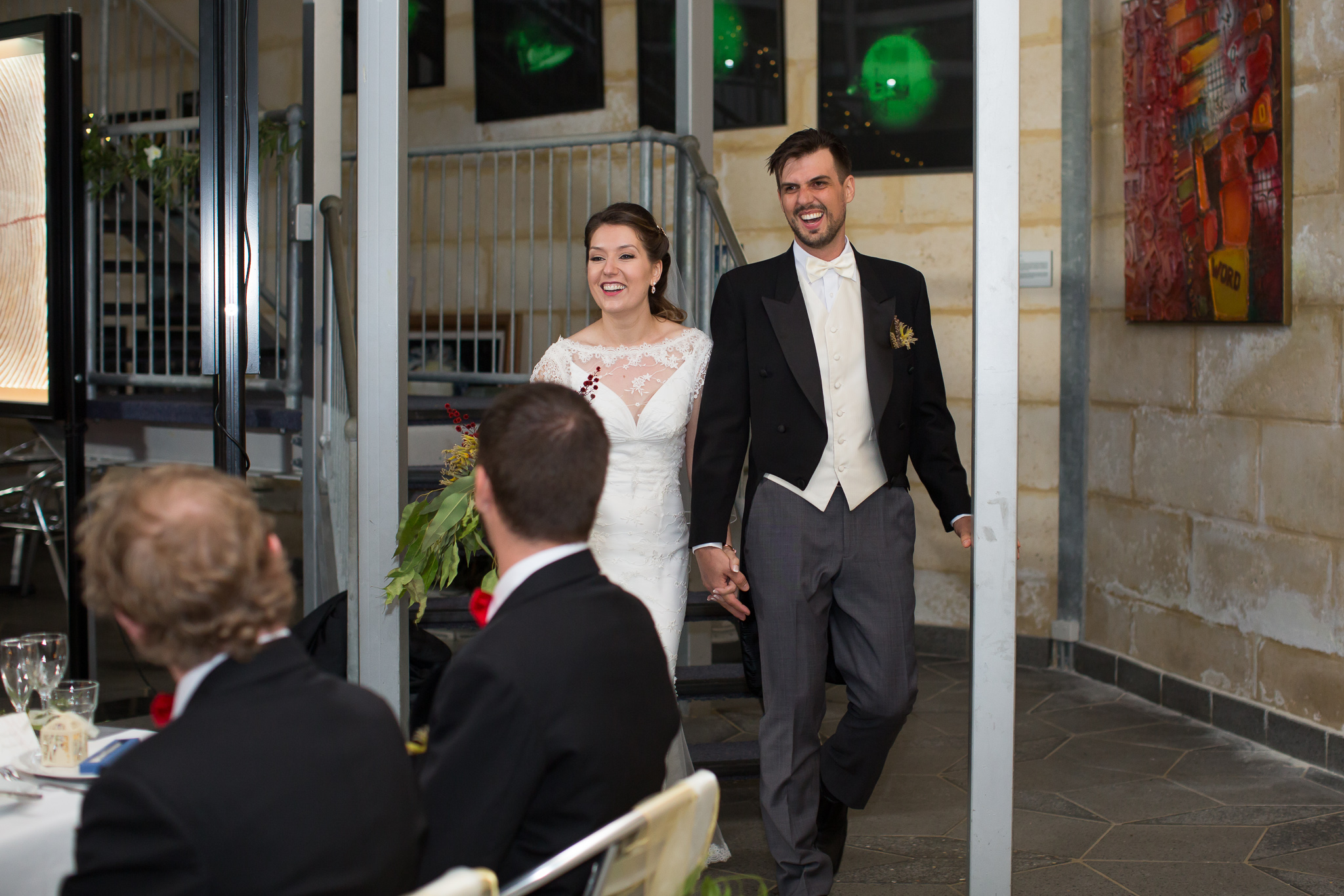 Bride and groom enter their reception at the Gravity Discovery Centre