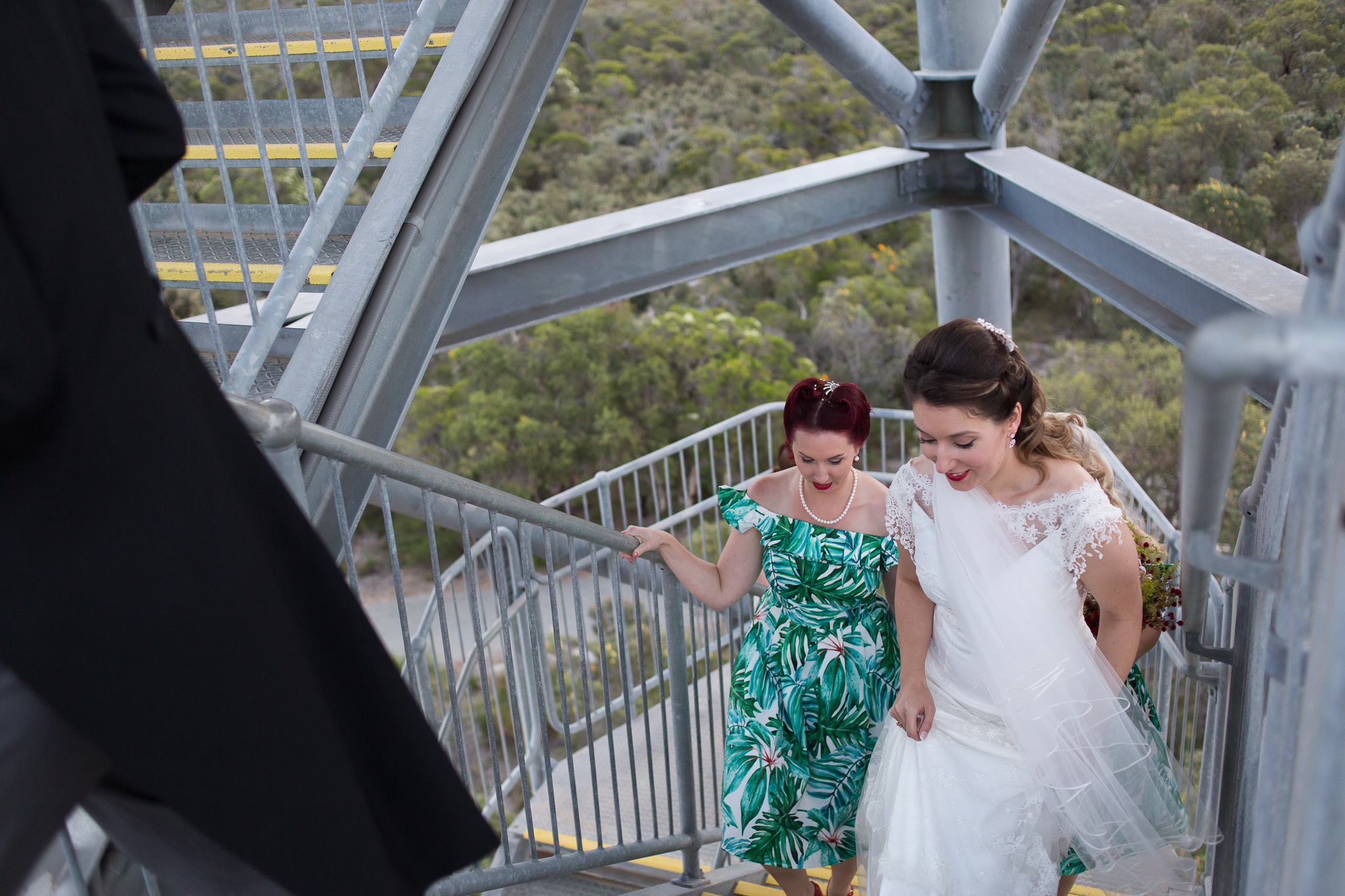 Bride walks up the stairs of the leaning gravity tower