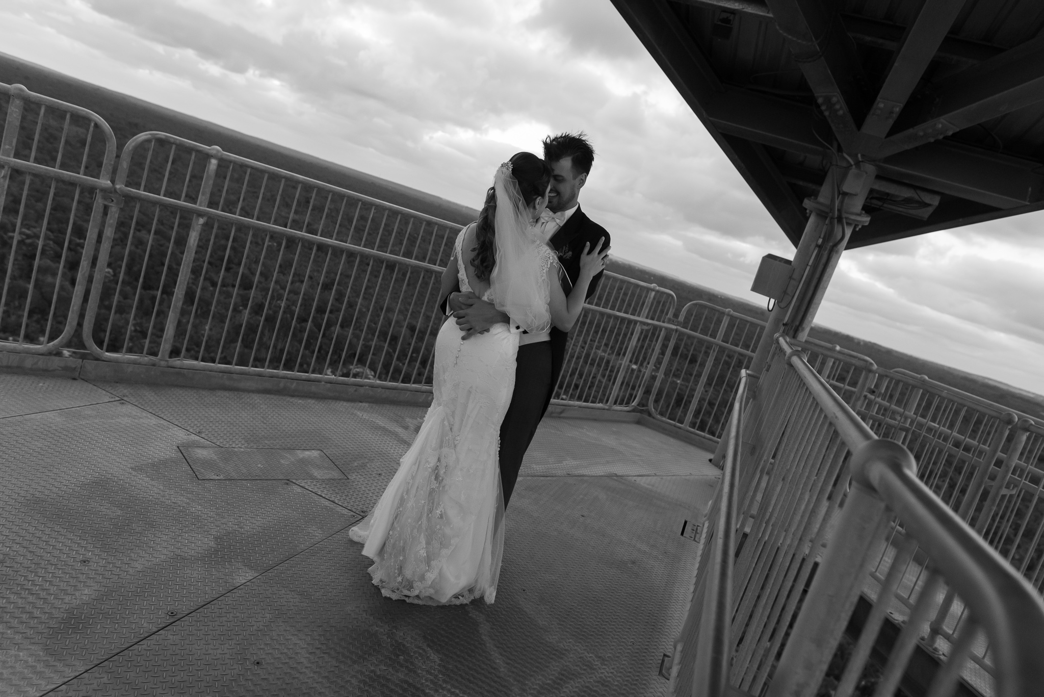 Bridal couple dancing a the top of the leaning gravity tower at Gin Gin