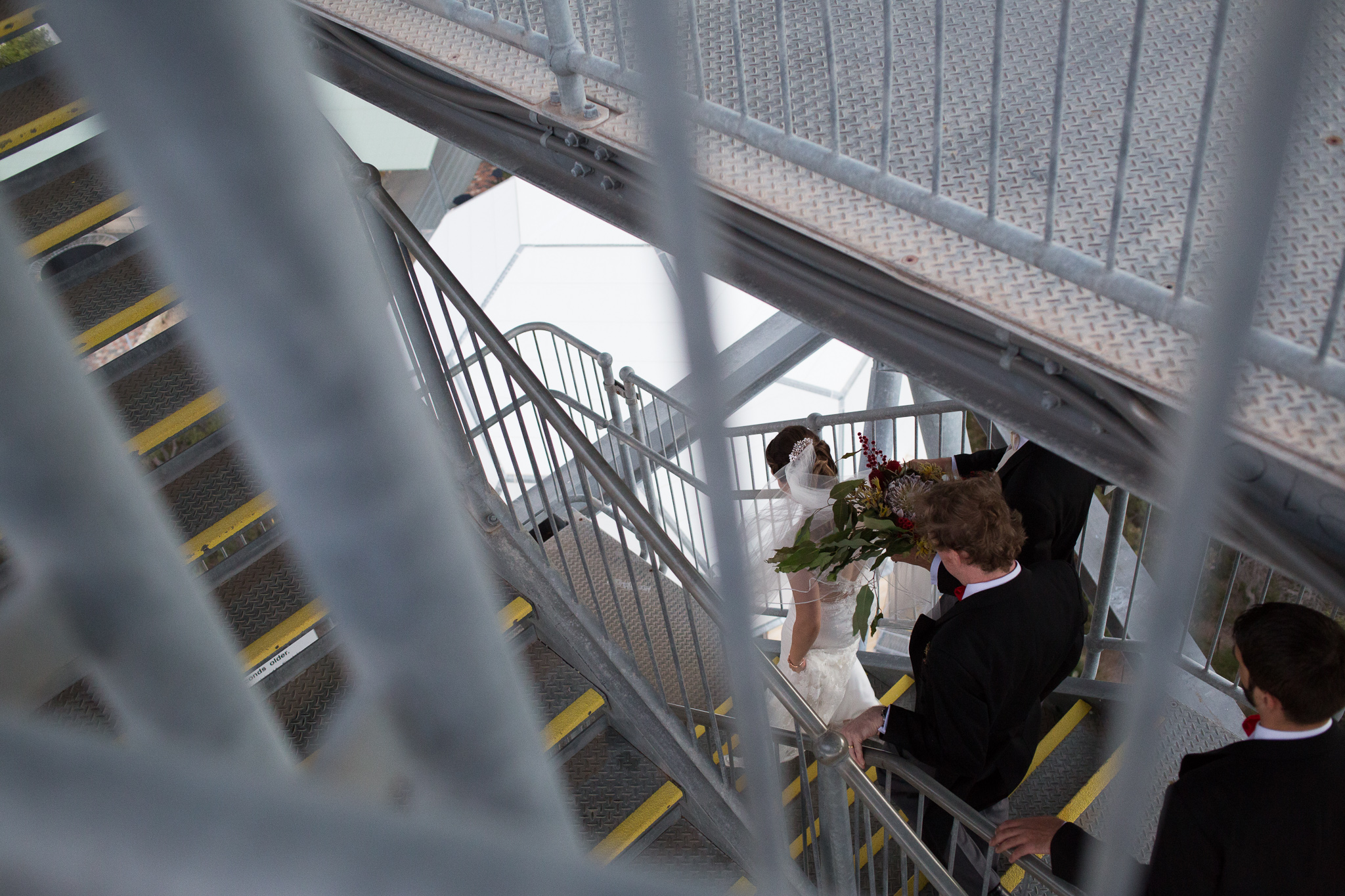 Bridal party walking down the leaning gravity tower at the GDC