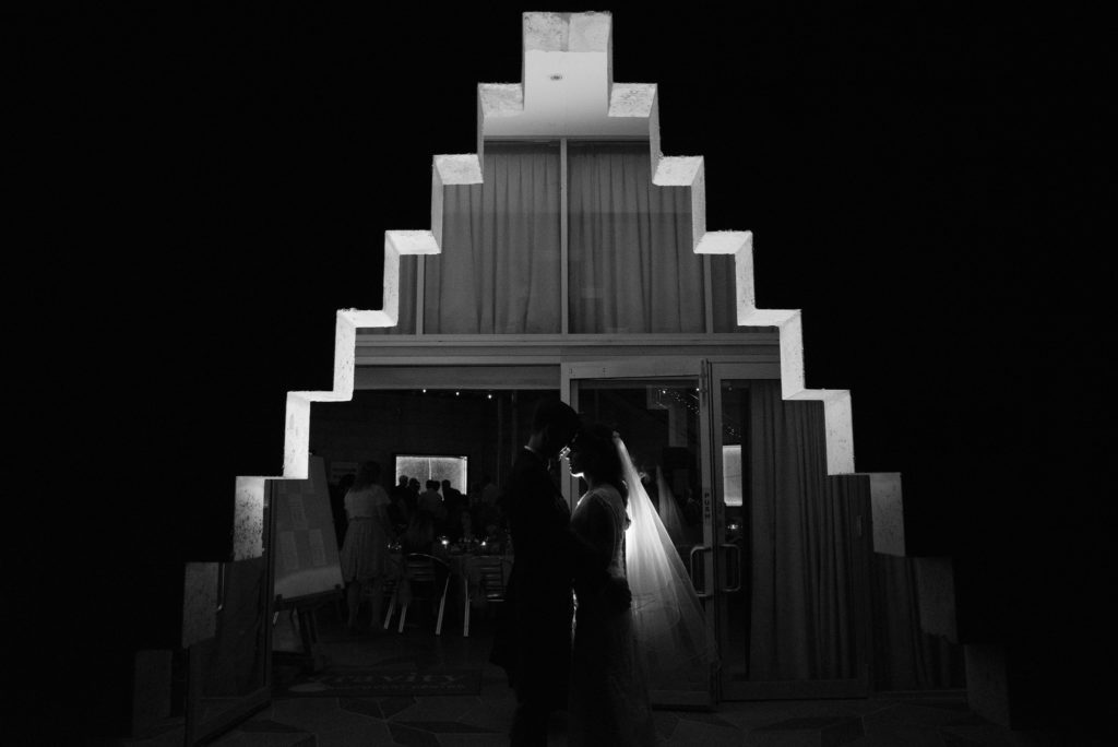 Backlit portrait of bridal couple in unusual entrance of Gravity Discovery Centre's cosmology gallery