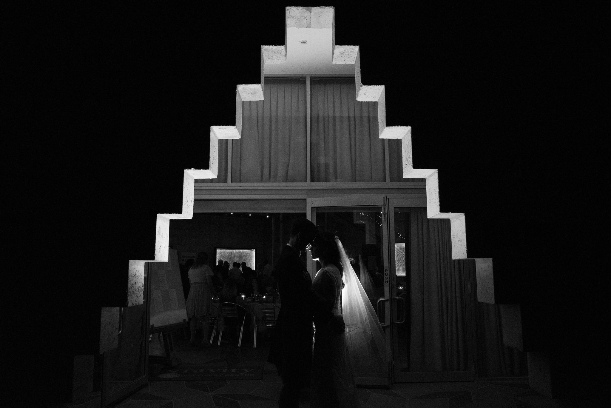 Backlit portrait of bridal couple in unusual entrance of Gravity Discovery Centre's cosmology gallery