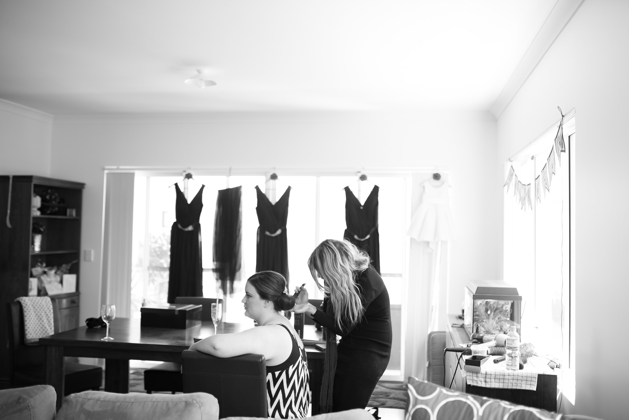 bride has her hair done in her house