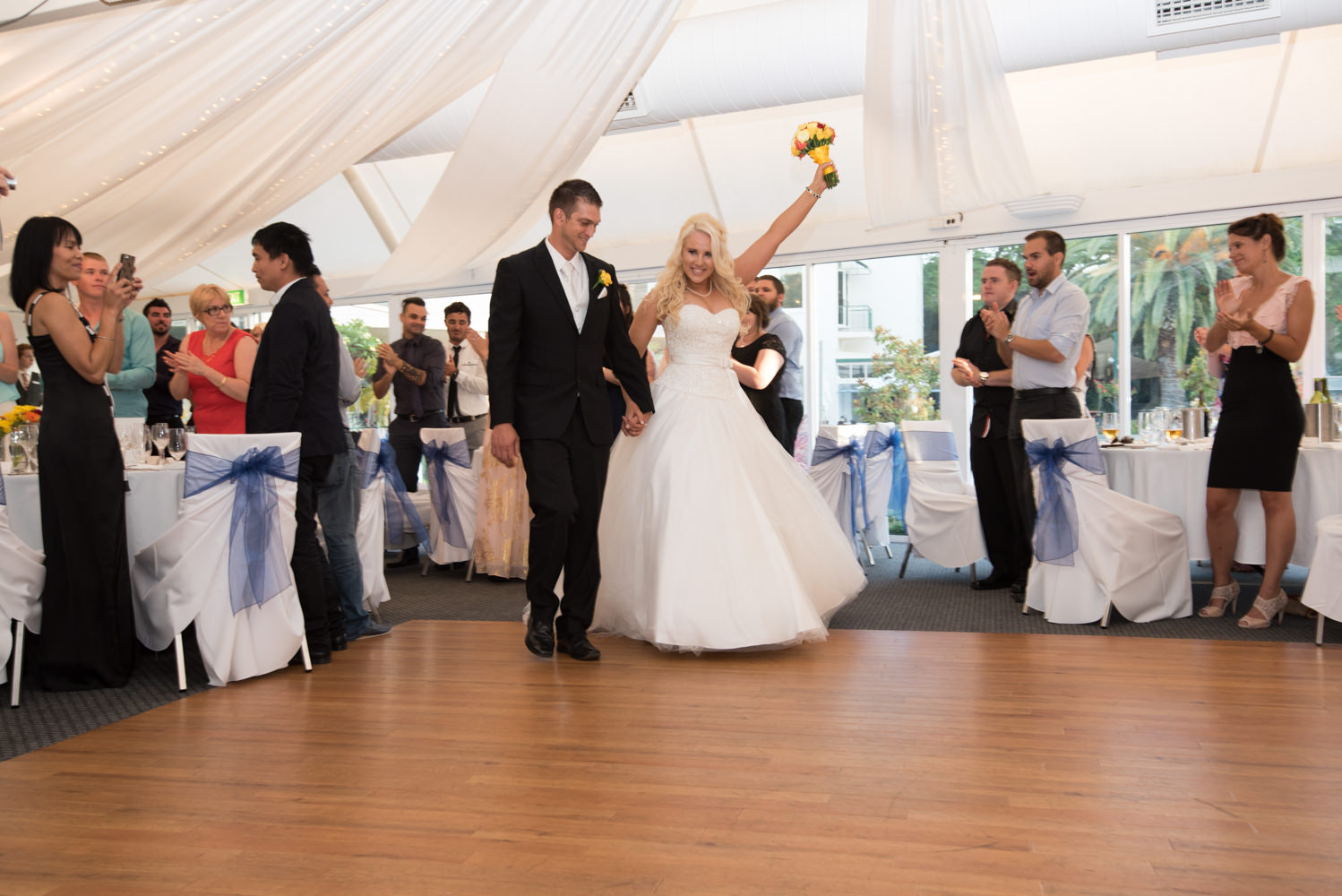 Bride and groom entering reception