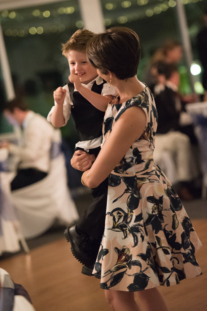 Wedding guest dancing with her son