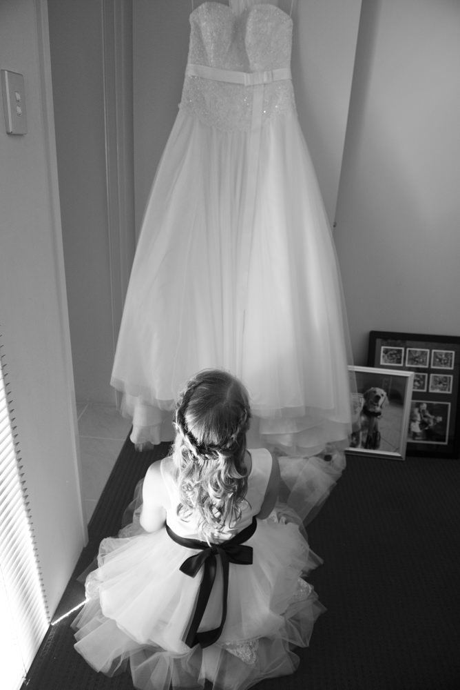 Flowergirl looking at the wedding dress