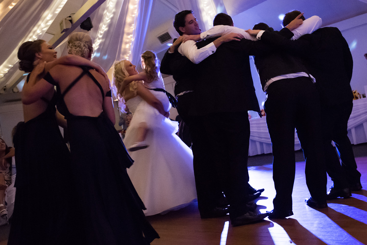 bridal party on the dance floor at Joondalup resort backlit