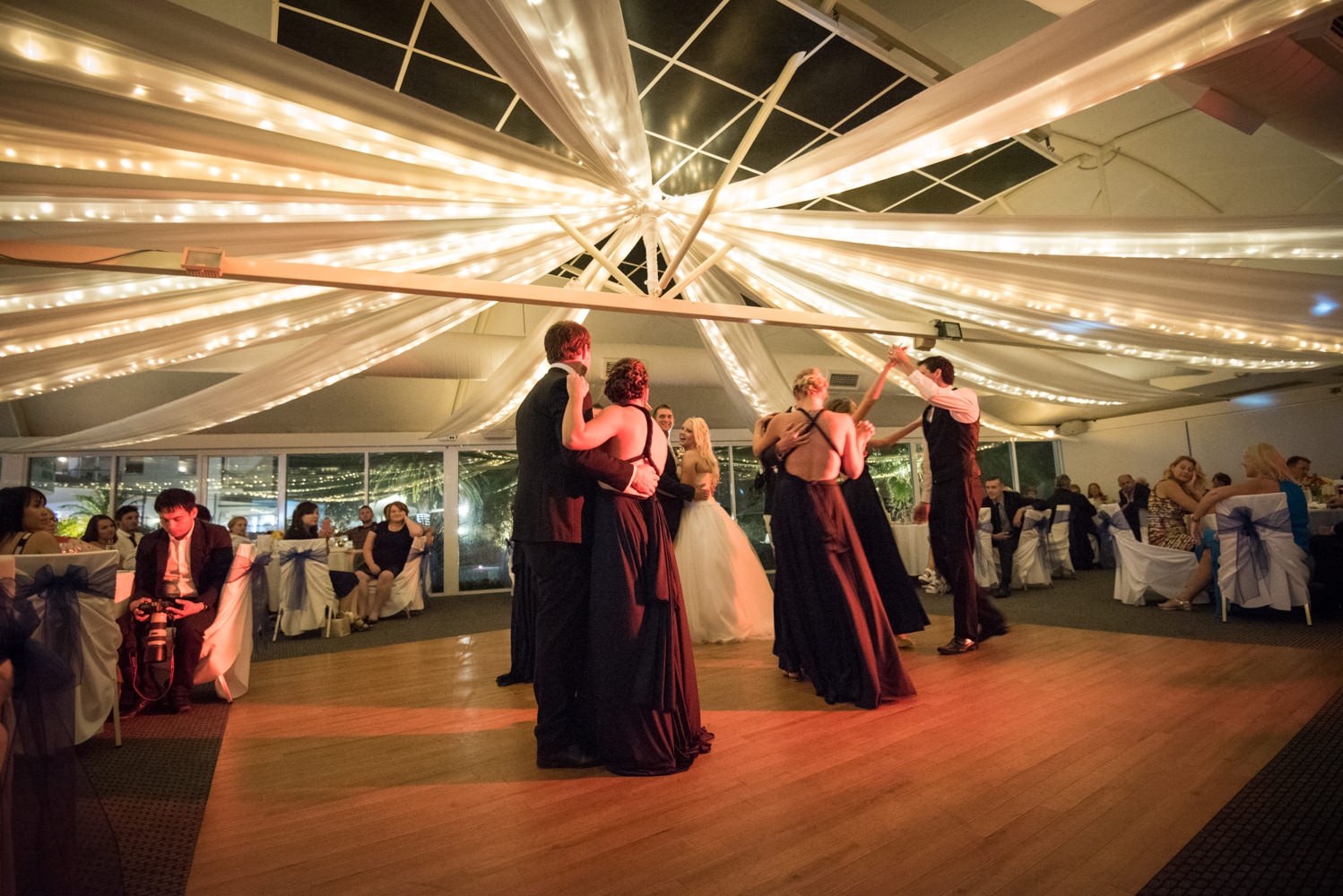 bridal party on the dance floor at Joondalup resort with red light