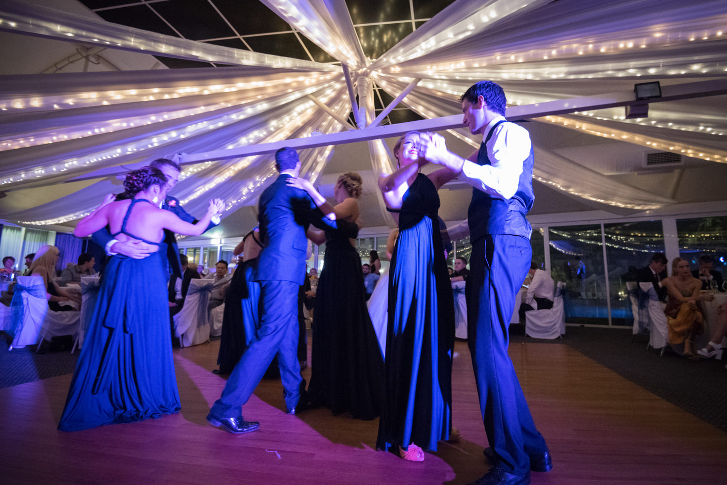 bridal party on the dance floor at Joondalup resort with blue light