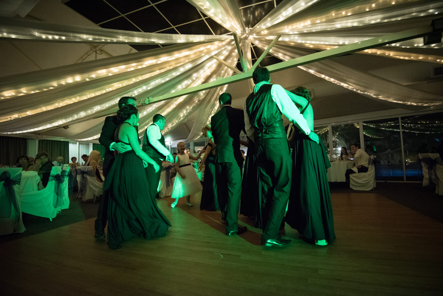 bridal party on the dance floor at Joondalup resort with green dance light