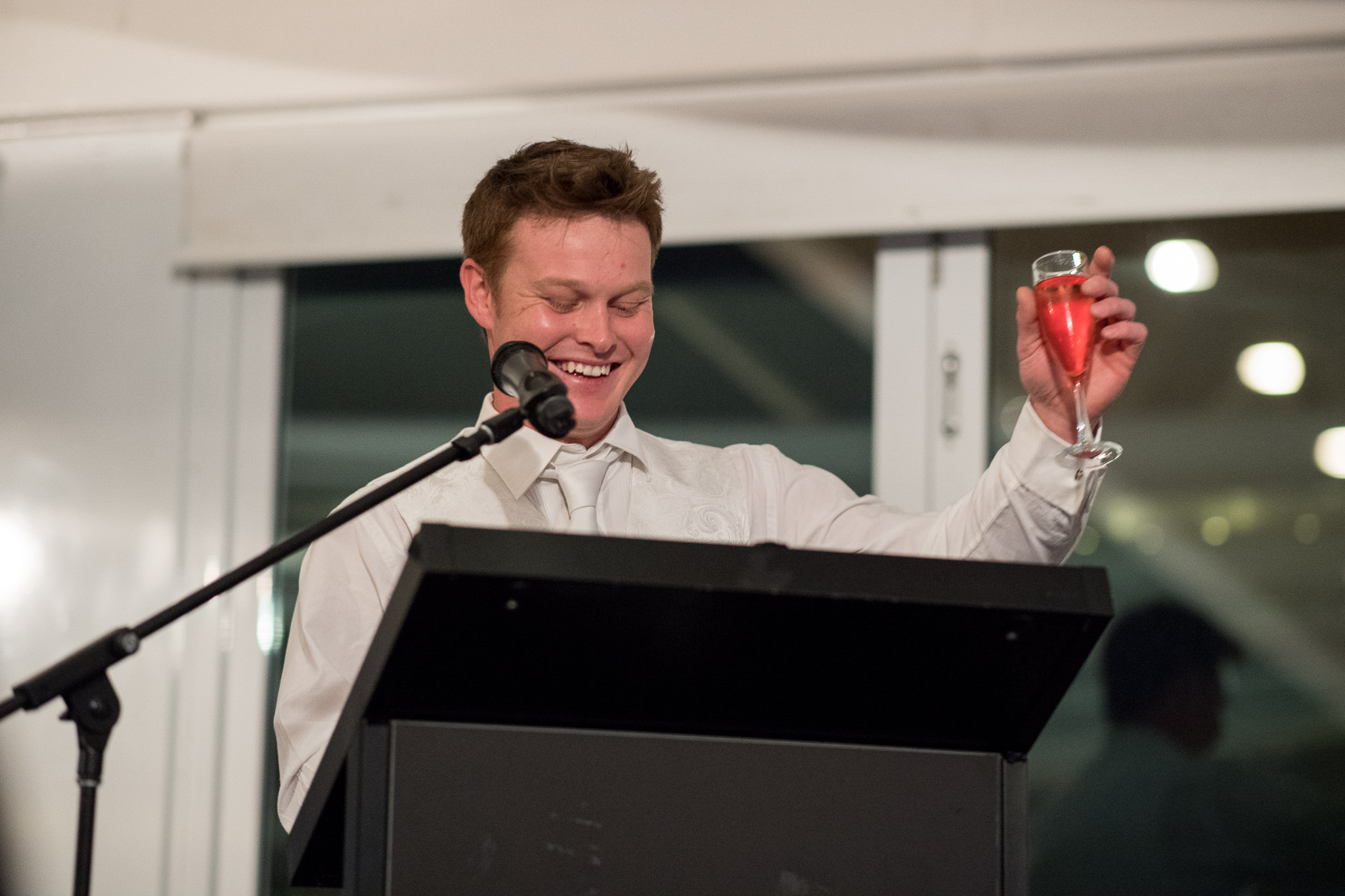 groom raises his glass during his speech