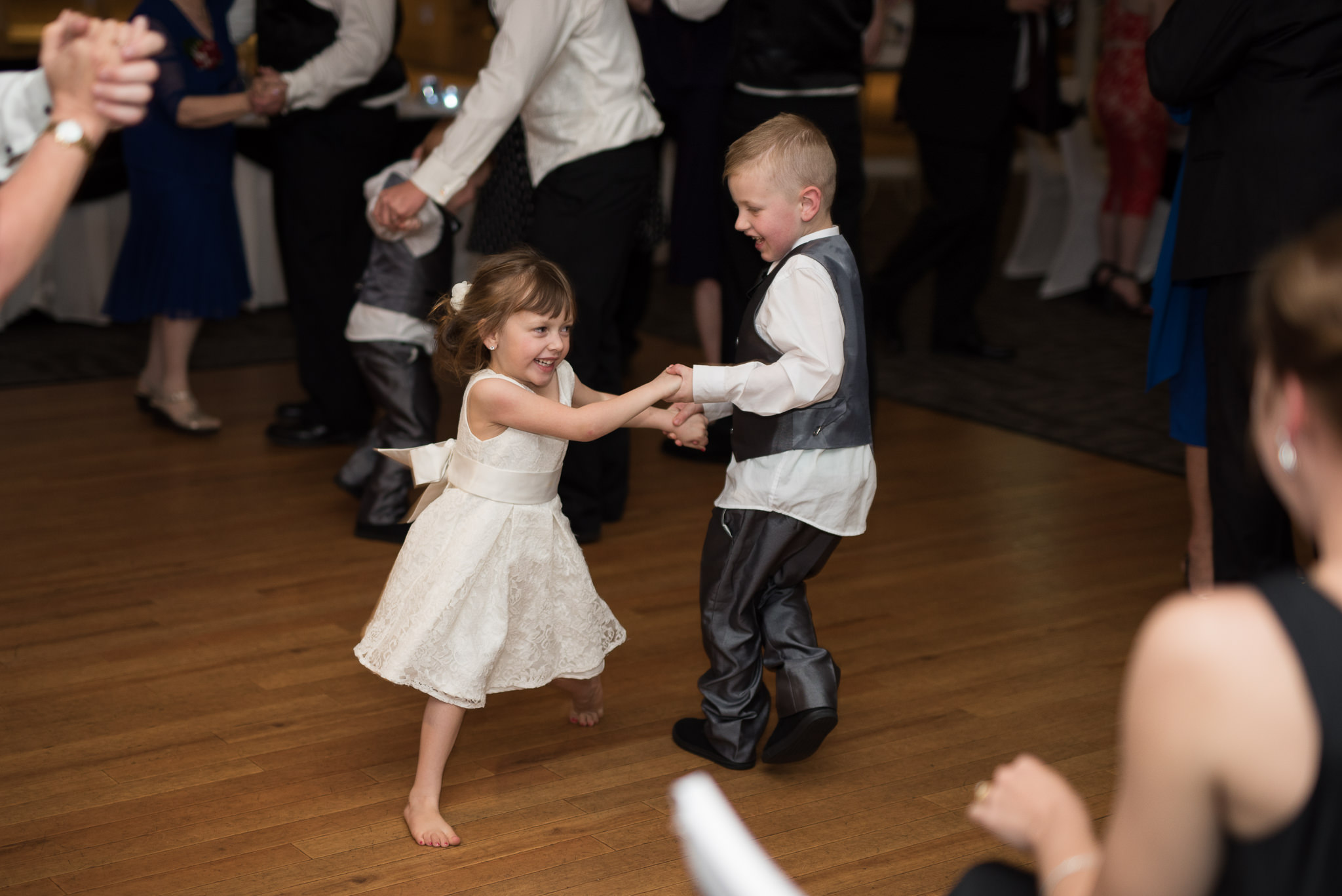 young wedding guests dancing barre foot on the dance floor