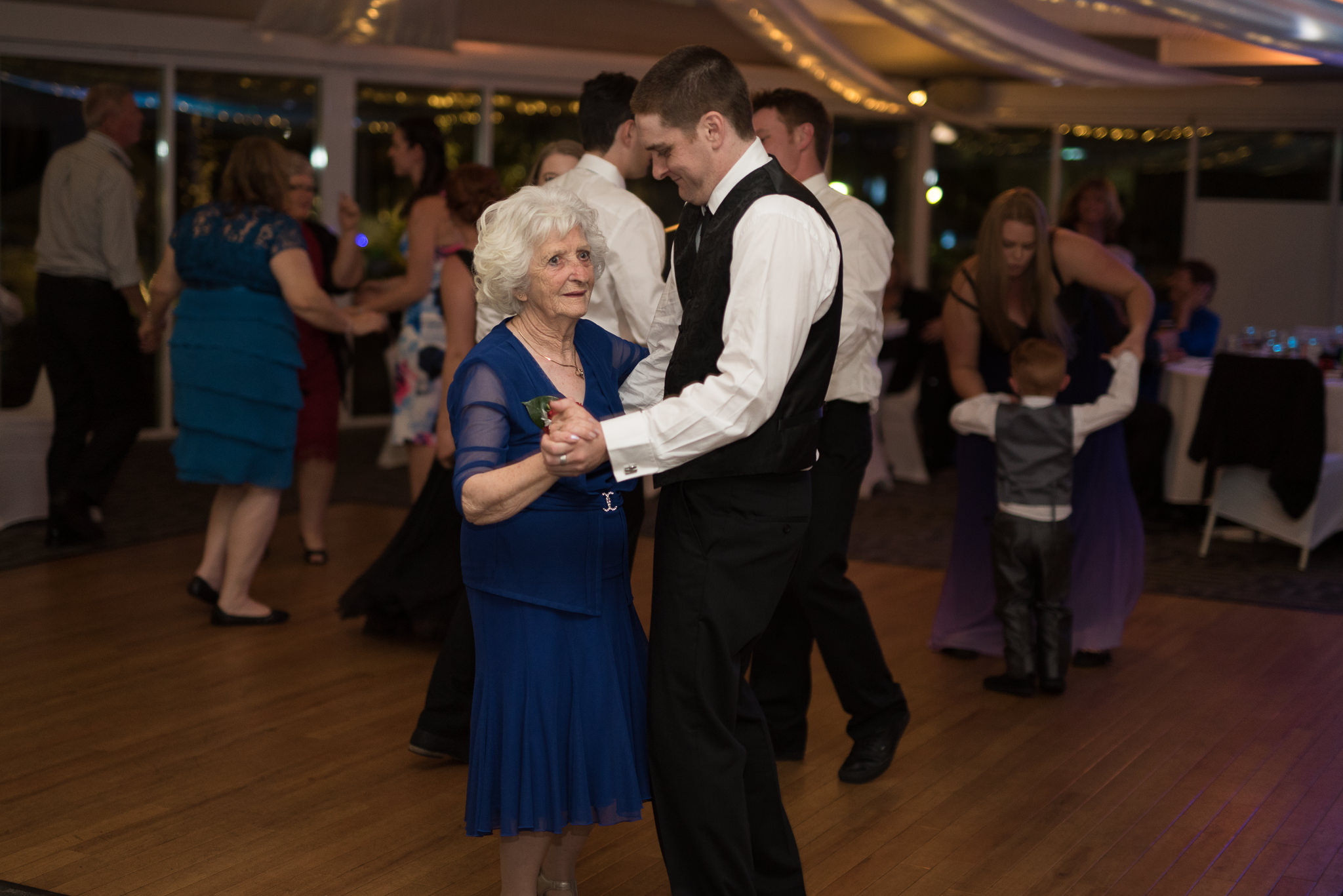 groomsman dancing with grandma at reception