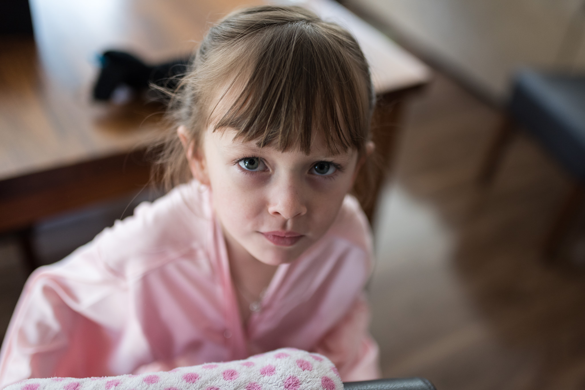 flower girl looks closely at camera