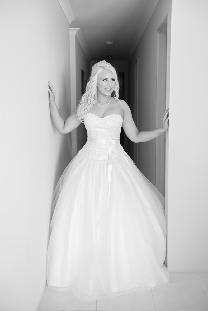 Bride dressed in wedding dress in hallway