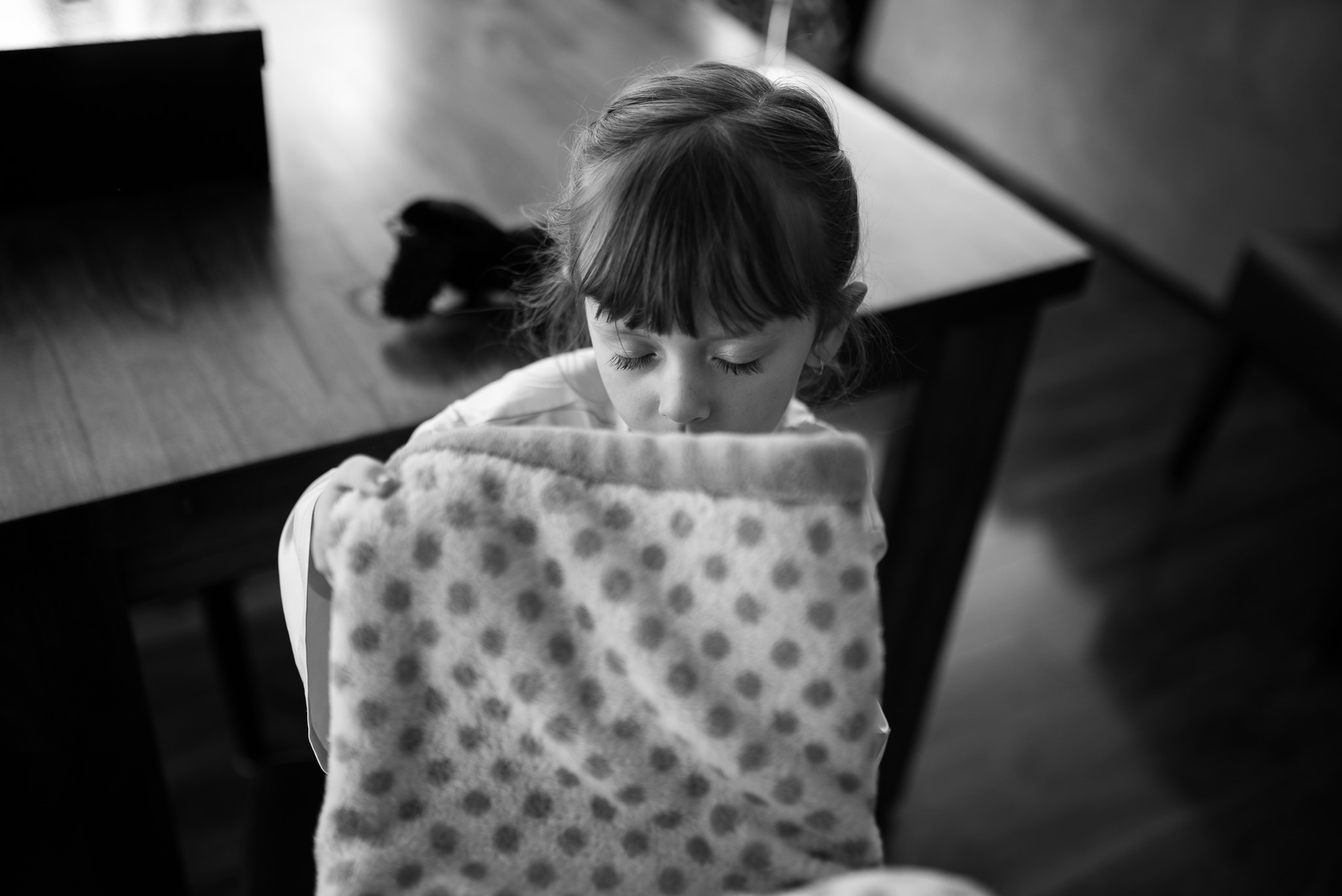 flower girl cuddling her blanket