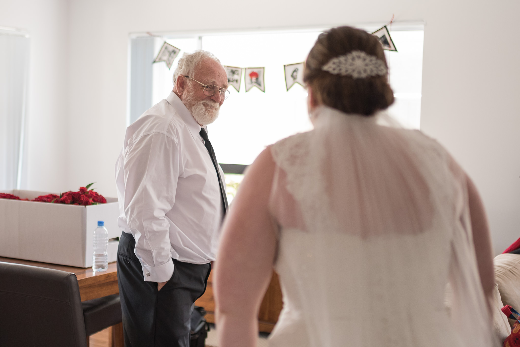 father smiles when he sees the bride