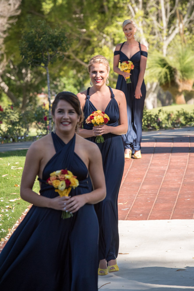 Bridesmaids walk down the aisle