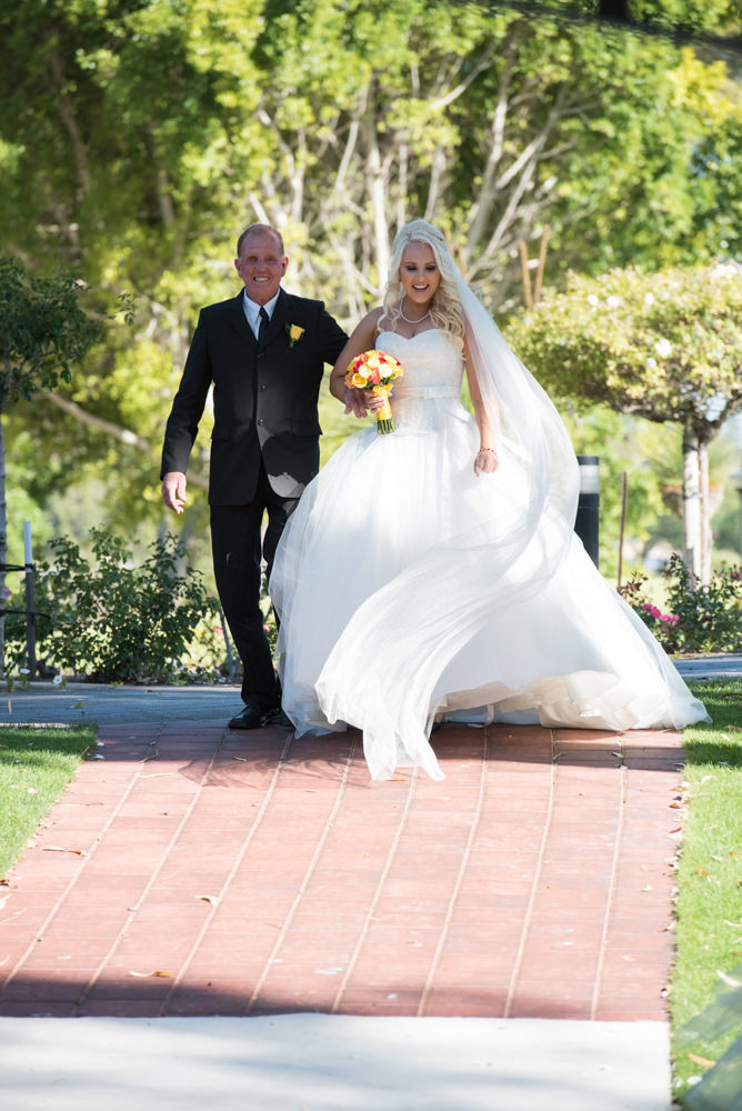 Bride and her father walk down the aisle