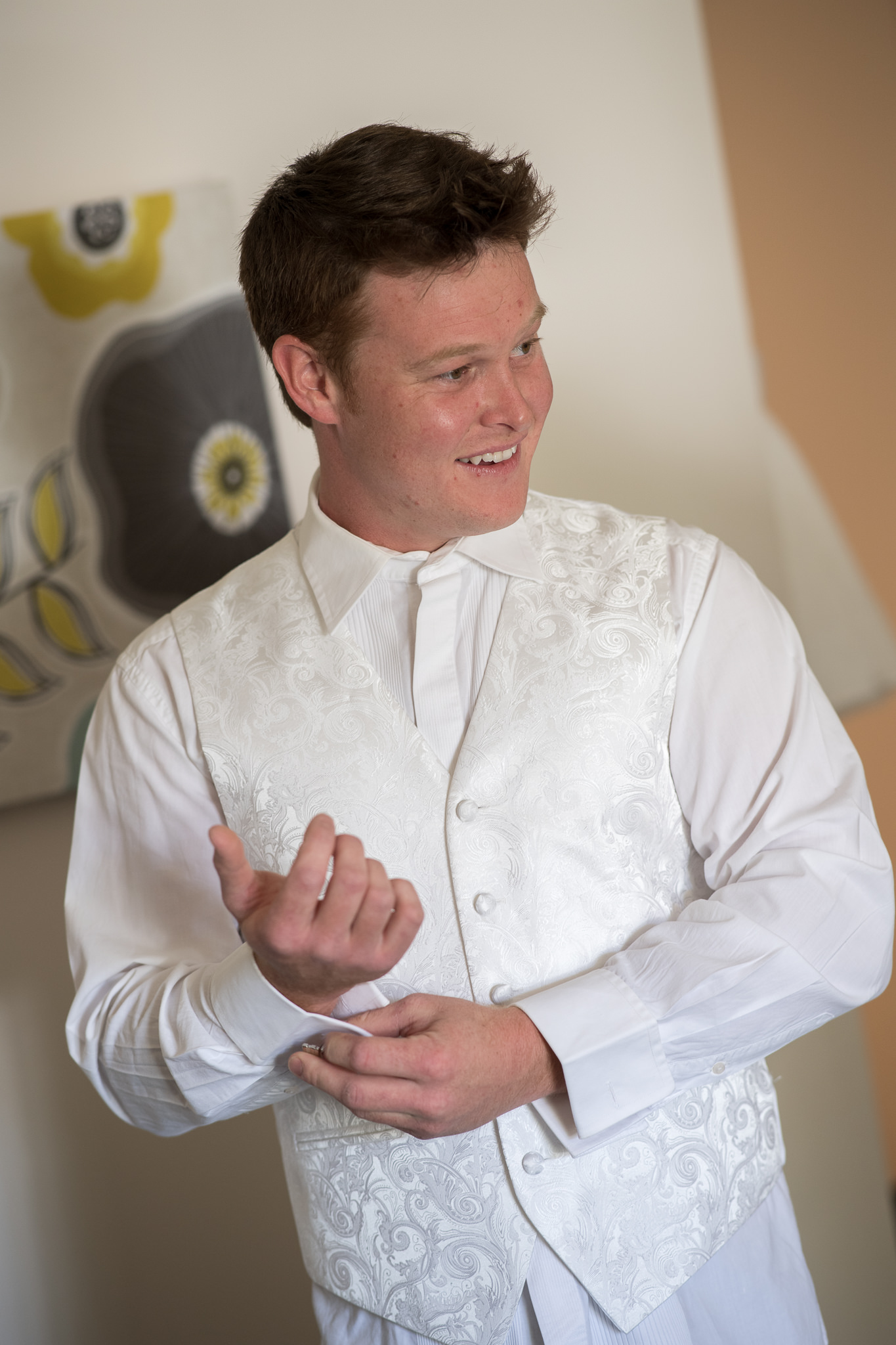 groom doing up his shirt cuffs