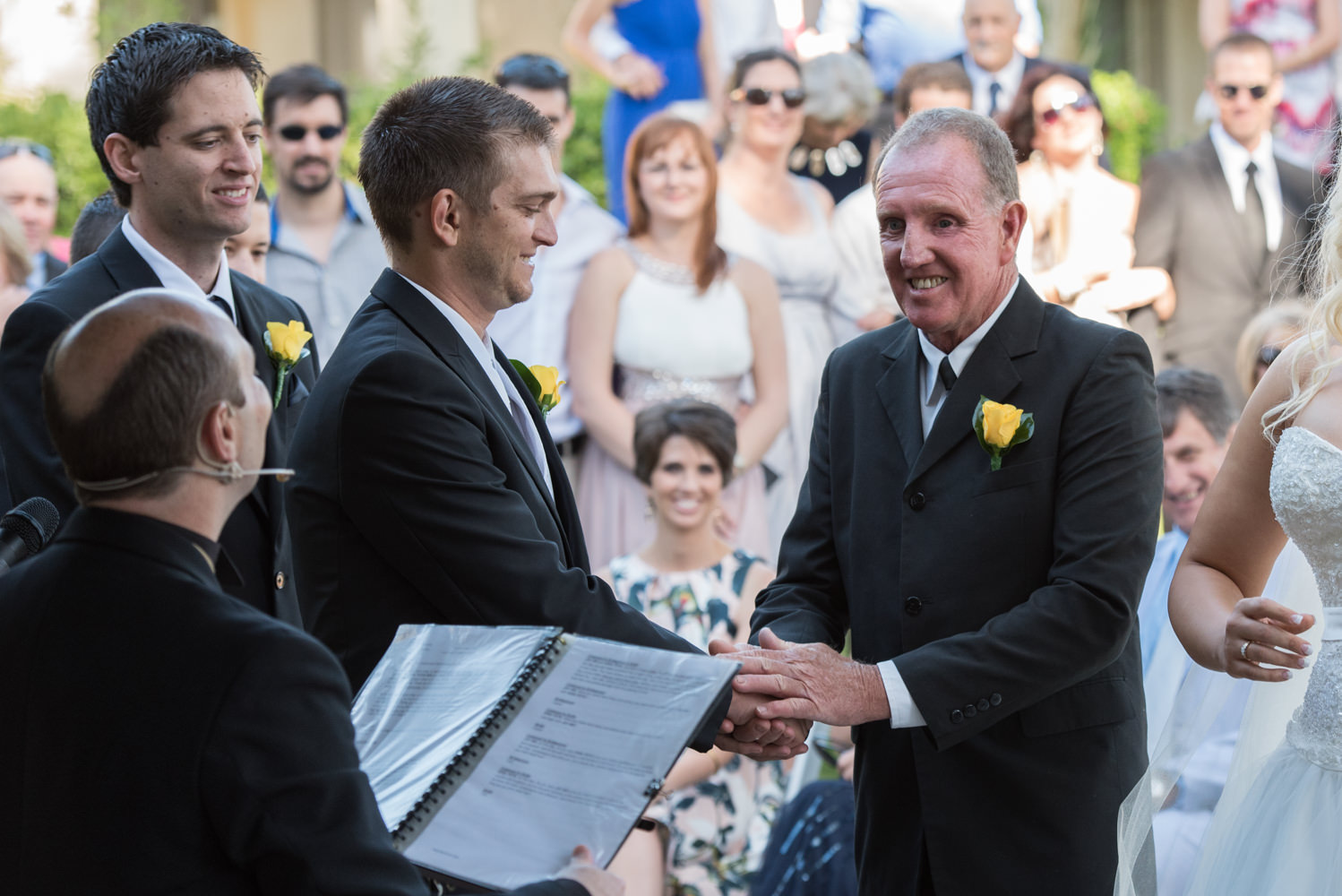 Bride's father shaking the groom's hand