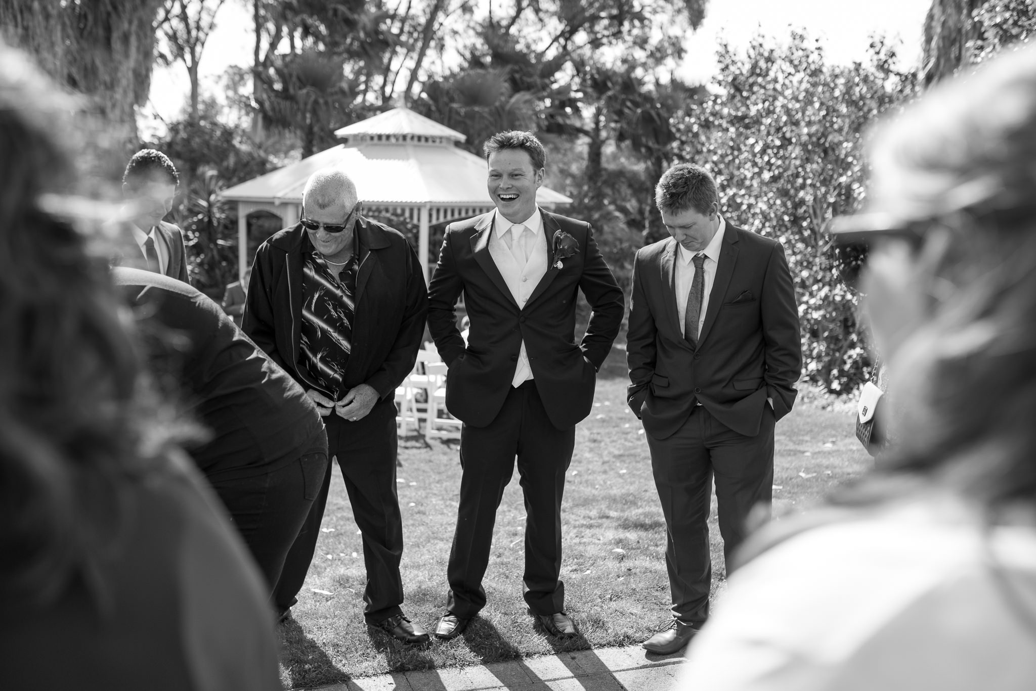 groom laughs with his friends waiting for ceremony to begin